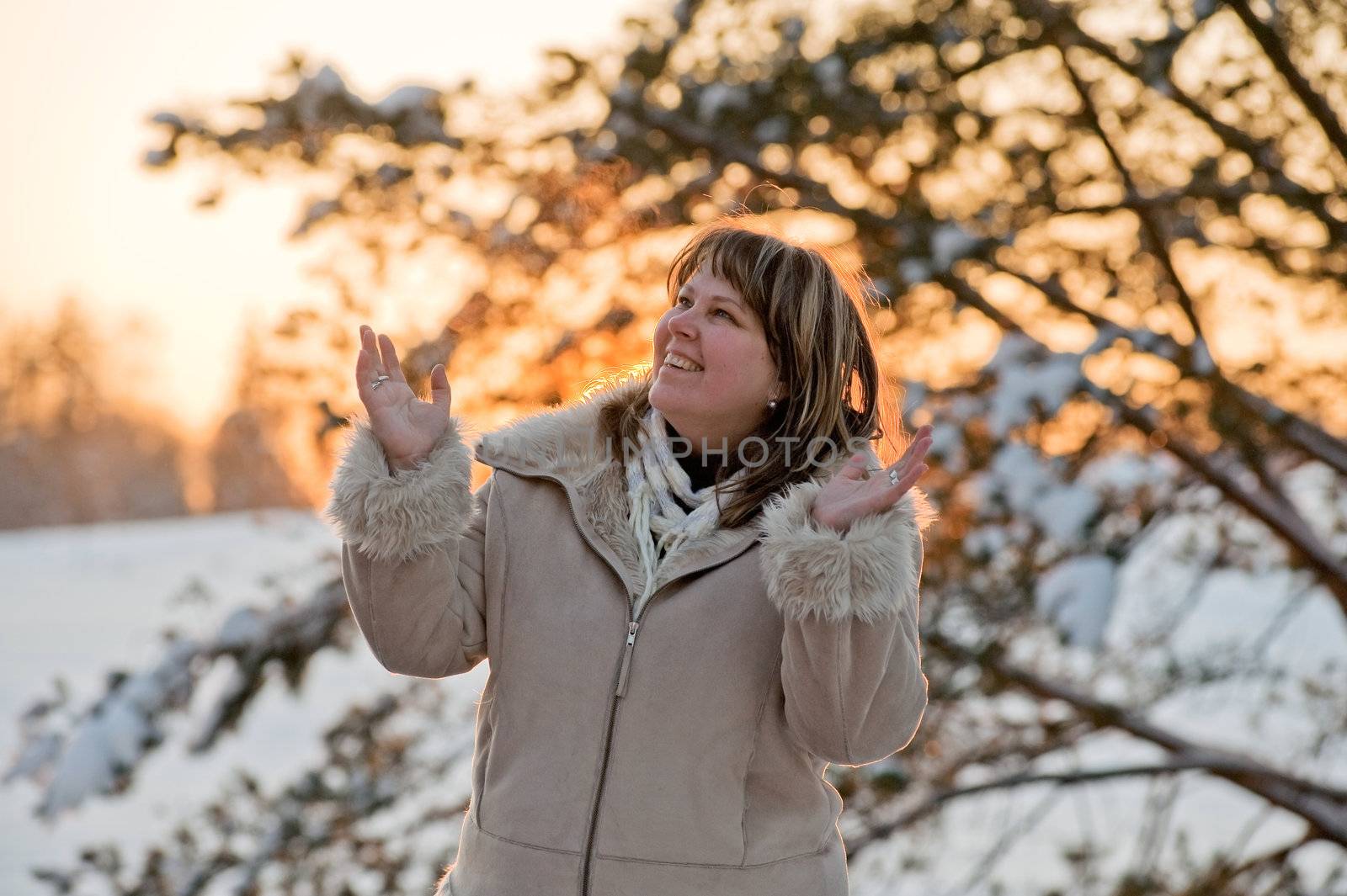 Happy middle-aged women having fun on winters sunset.