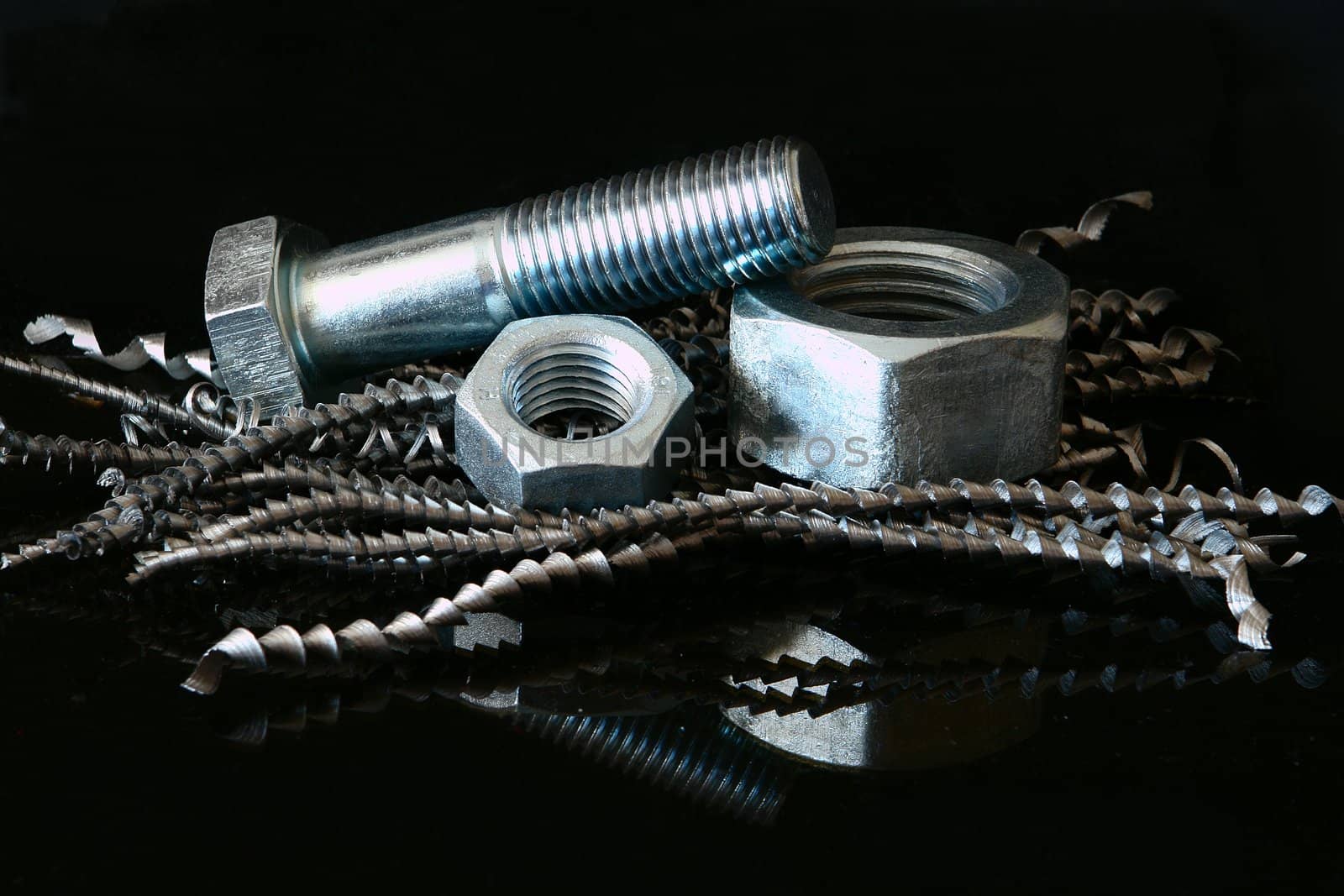  Two female screws and  screw-bolt on black background.                             