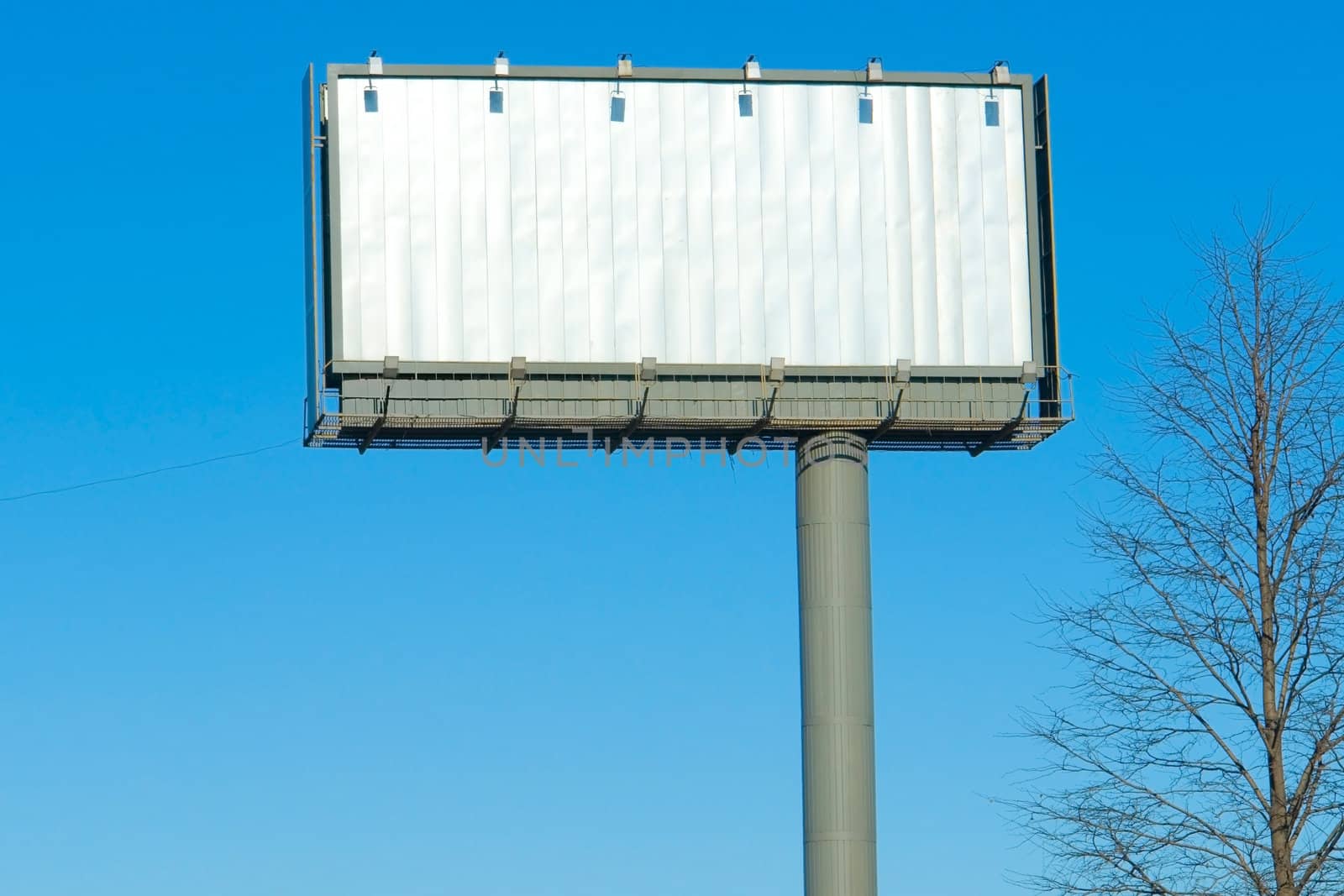 Blank billboard  against a blue sky.                           