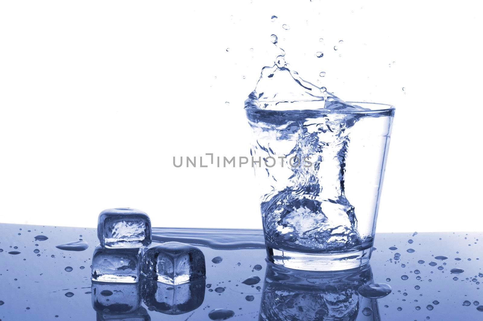 glass of ice water with bubbles on white background