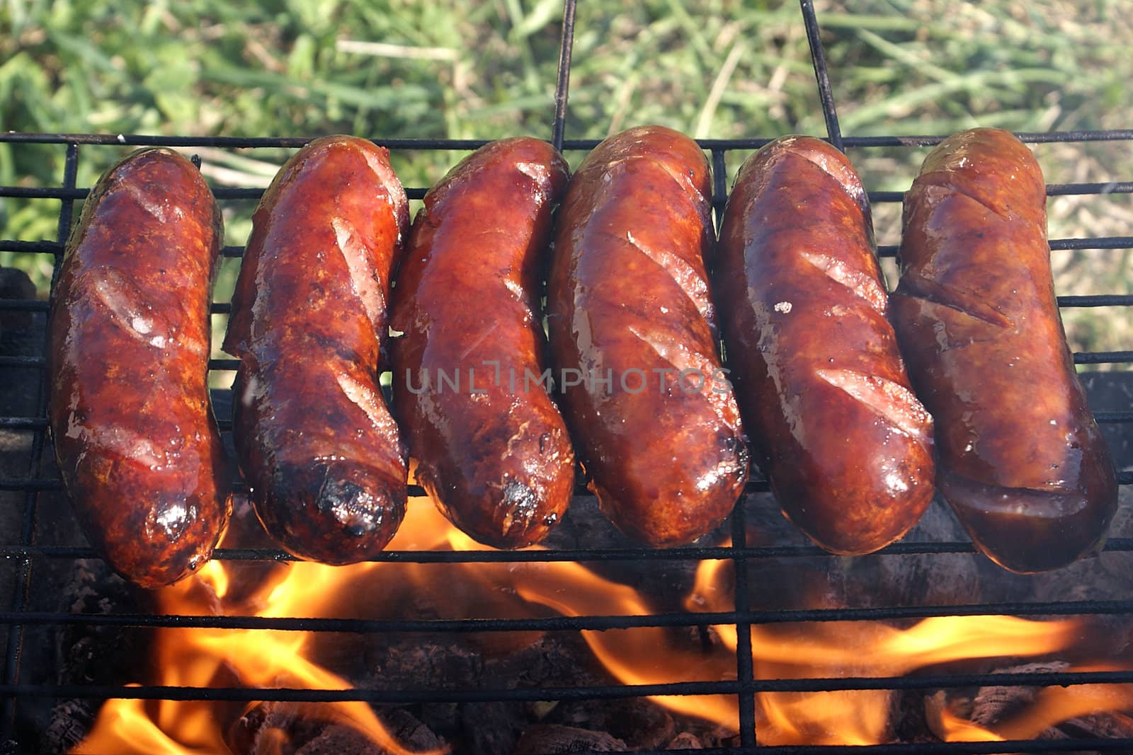 Grill sausages on a lattice