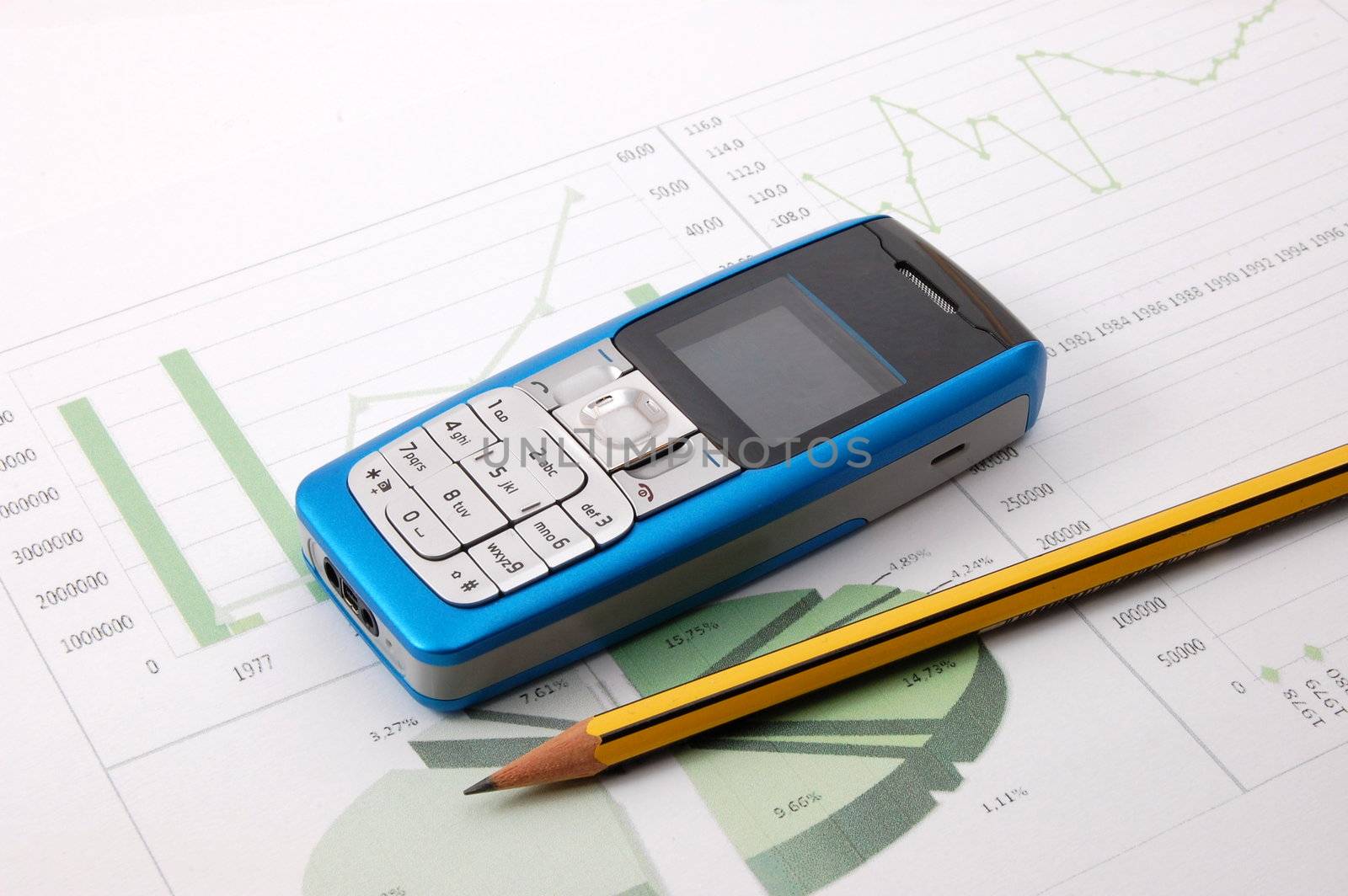 blue cell phone over business chart showing success