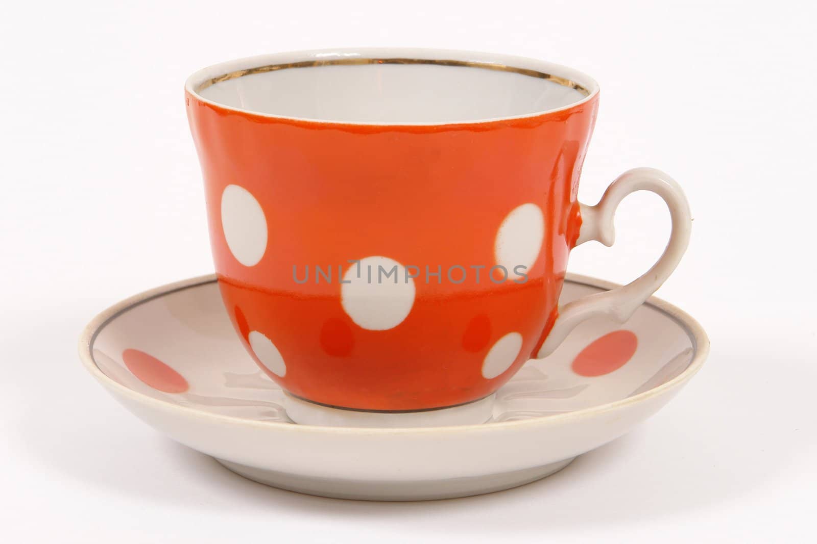 orange tea cup with white circle                             