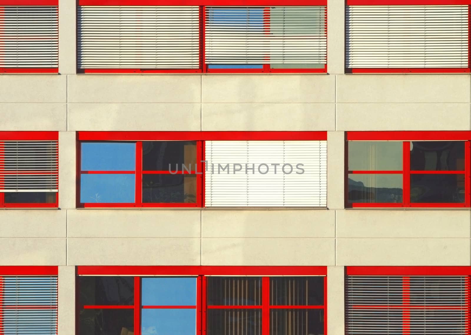 three lines of red windows in an office building
