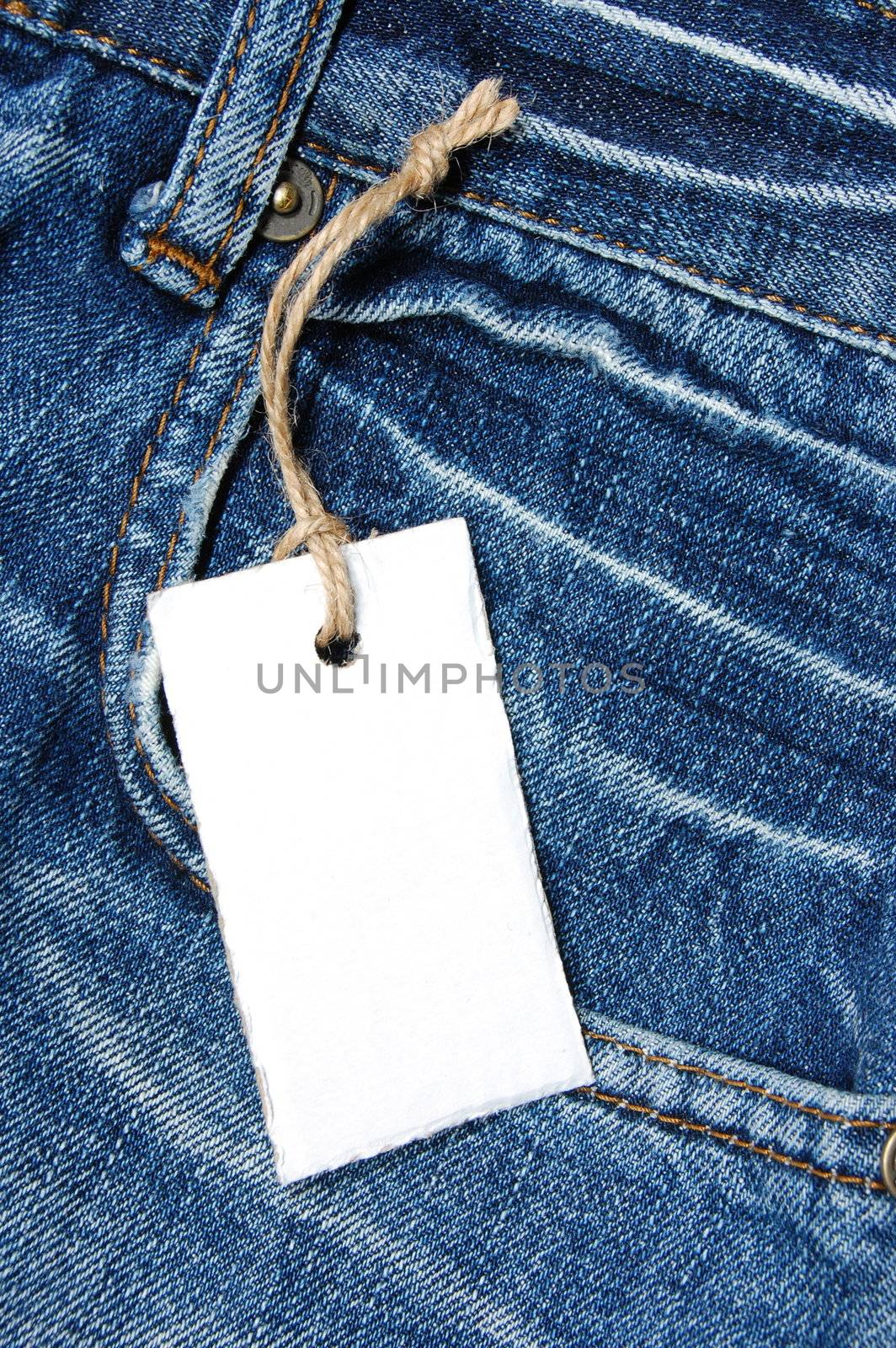 blank price tag with copyspace on a jeans texture
