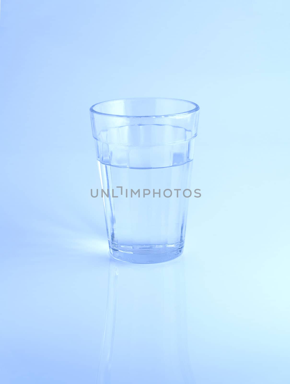 A glass of water on blue background