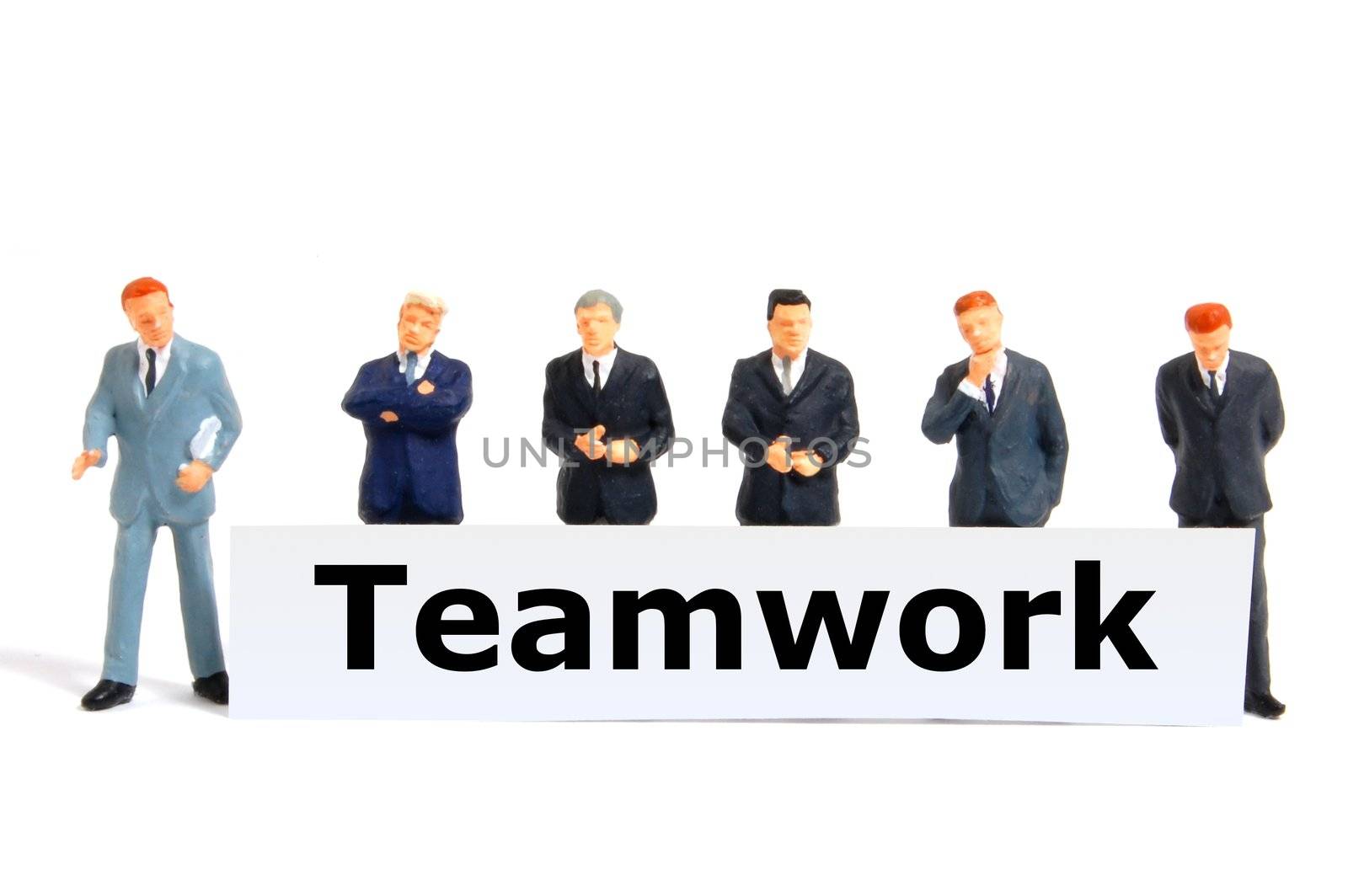 team or teamwork business concept with tiny toy business man isolated on white background