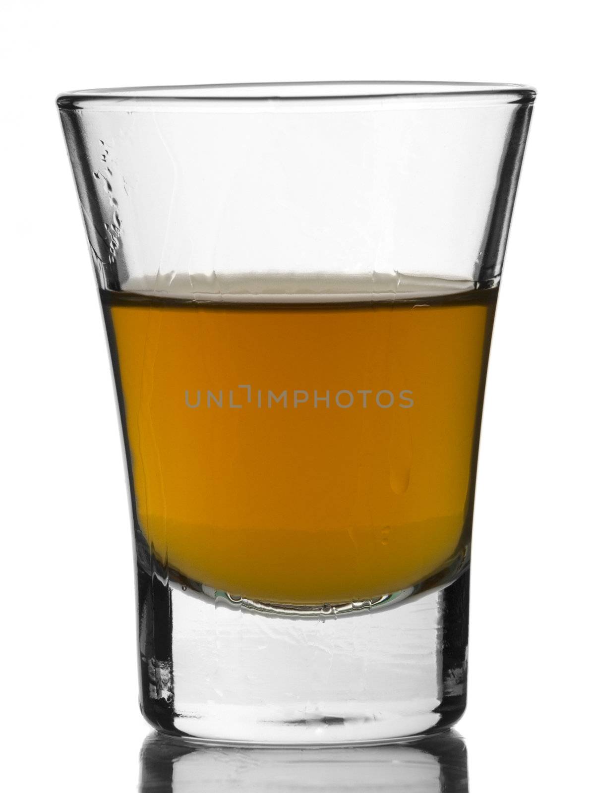 A shot of whisky on white background.