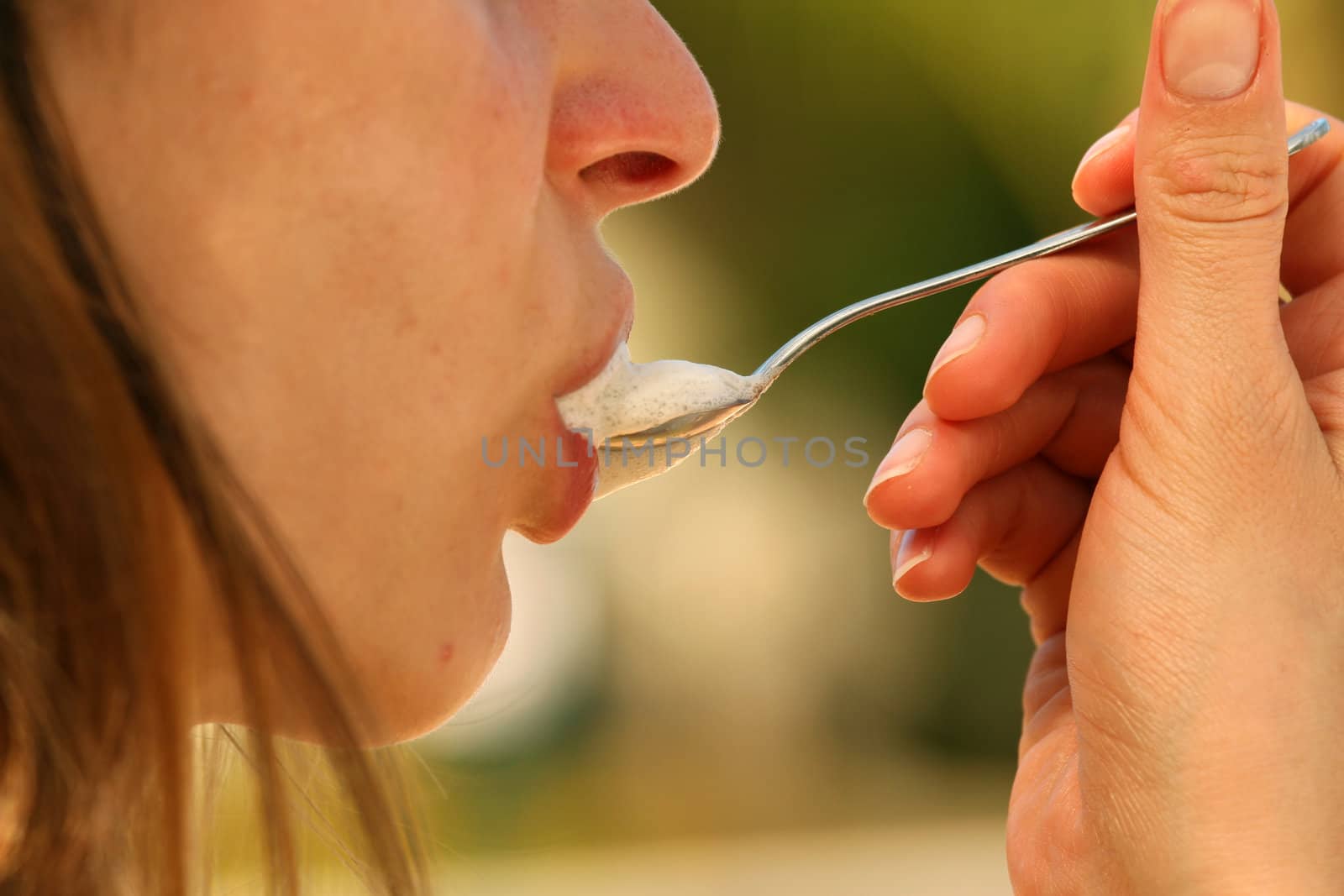 Girl holding a spoon with foam cappuchino