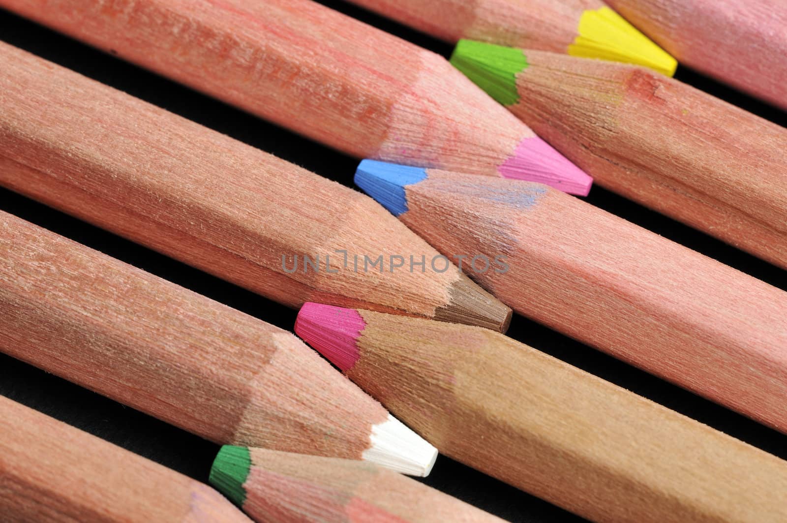 Colored pencils close up against black background
