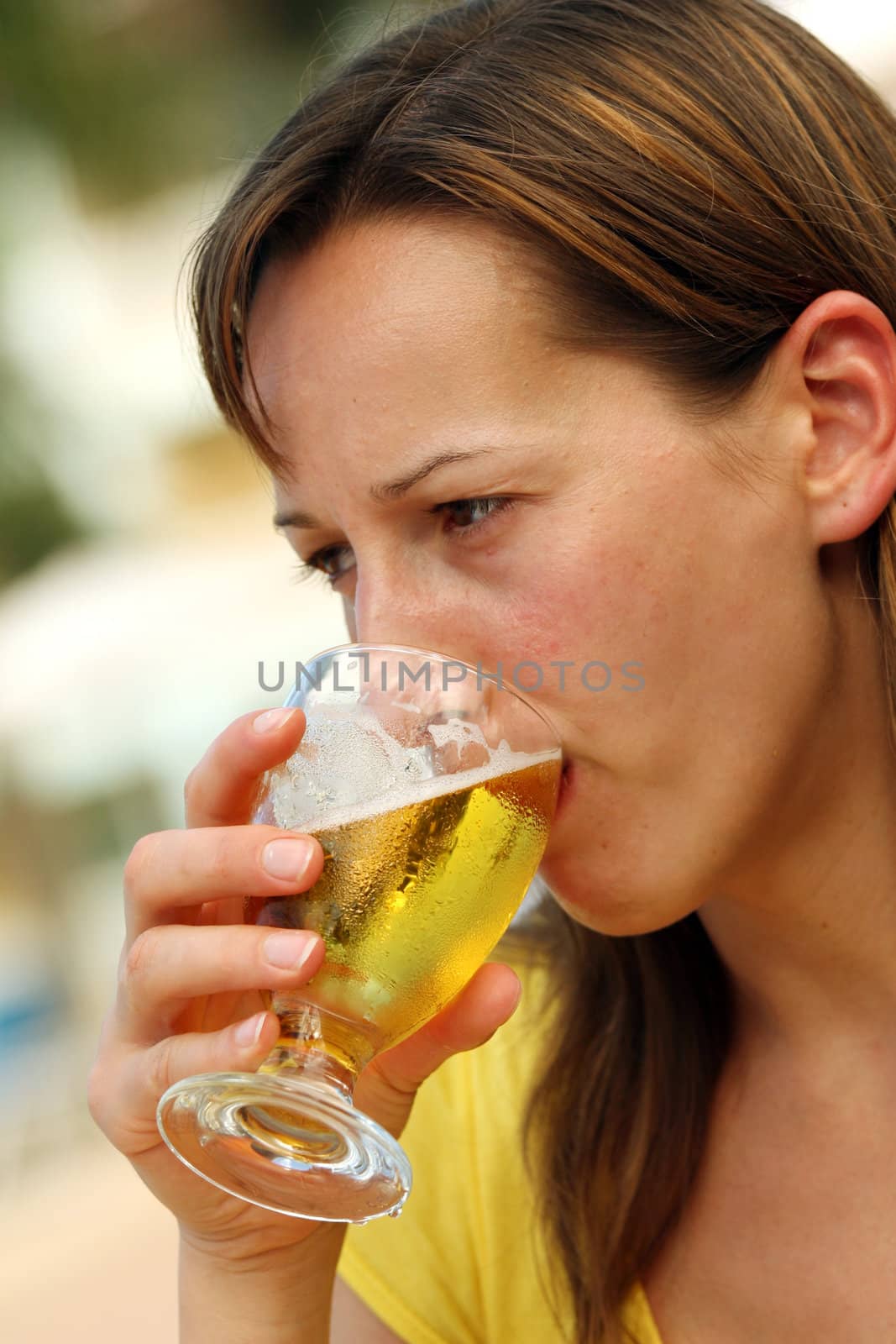 Girl drinking a glass cold and fresh beer