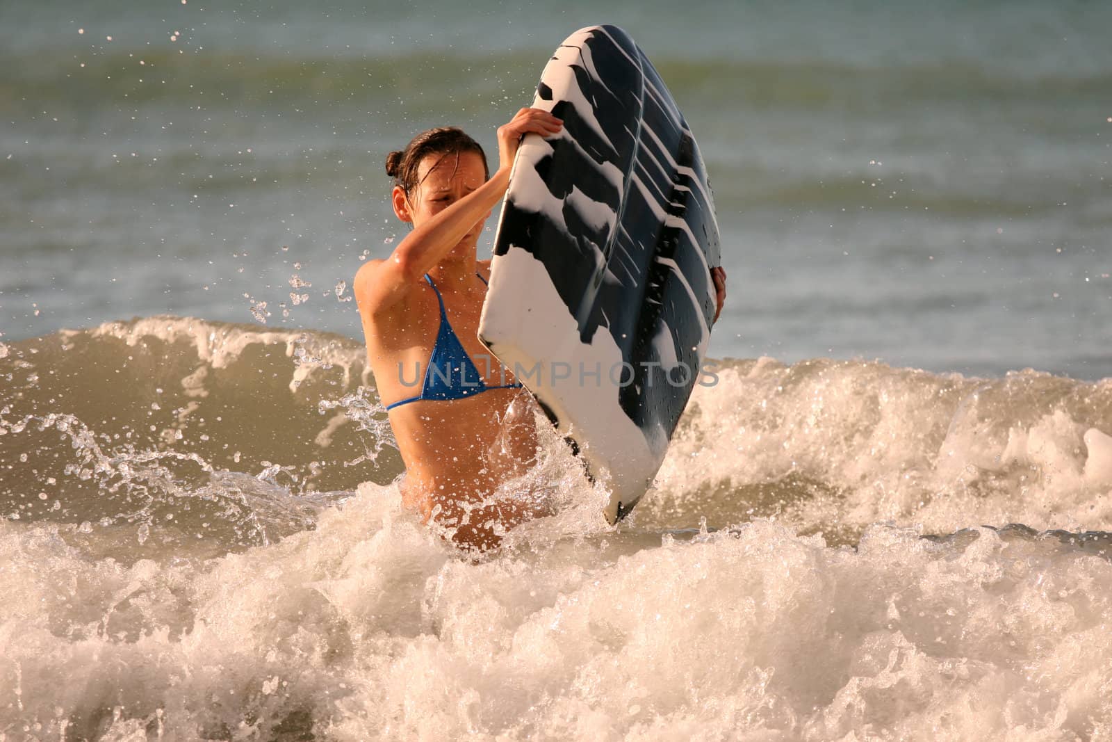 Bikini Girl with boogie board in the water