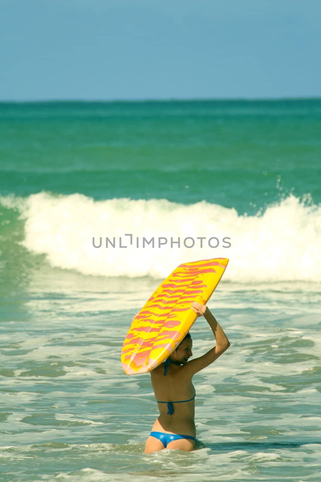 Bikini Girl with boogie board in the water