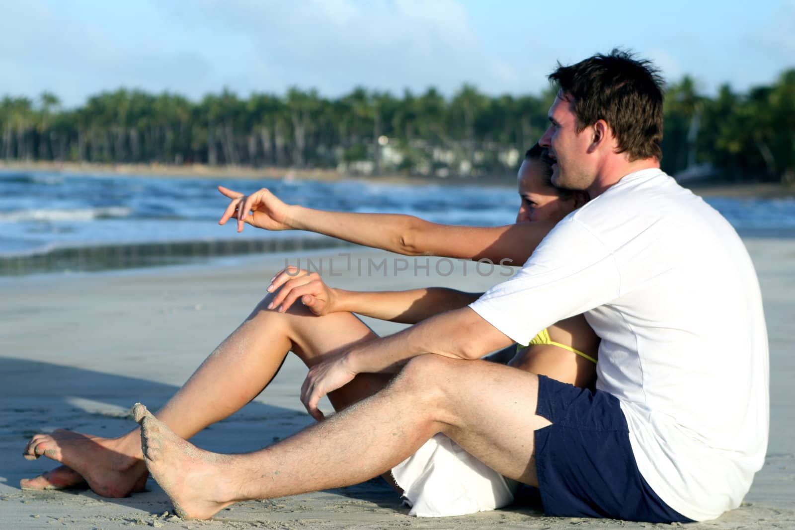 natural couple at the beach by sunset