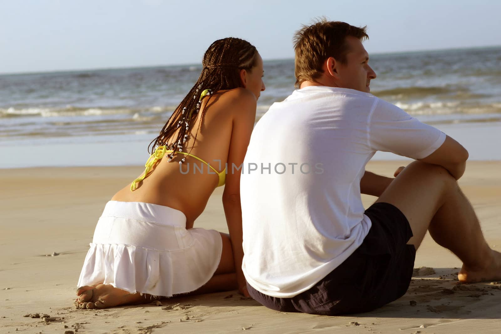couple at the beach by sunset