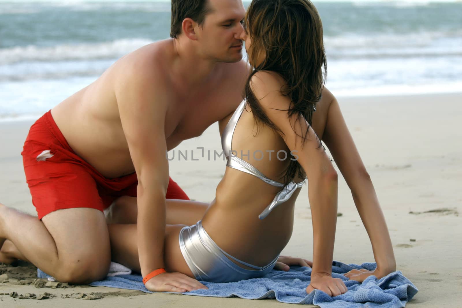 couple at the beach by sunset