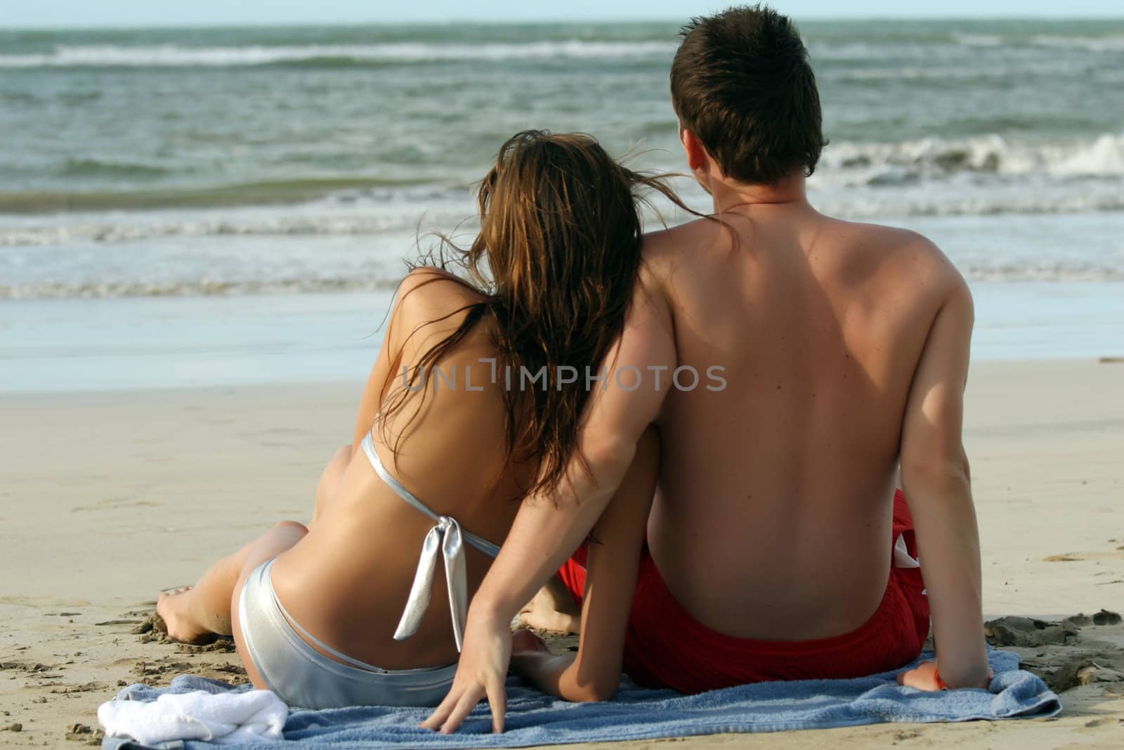 natural couple at the beach by sunset