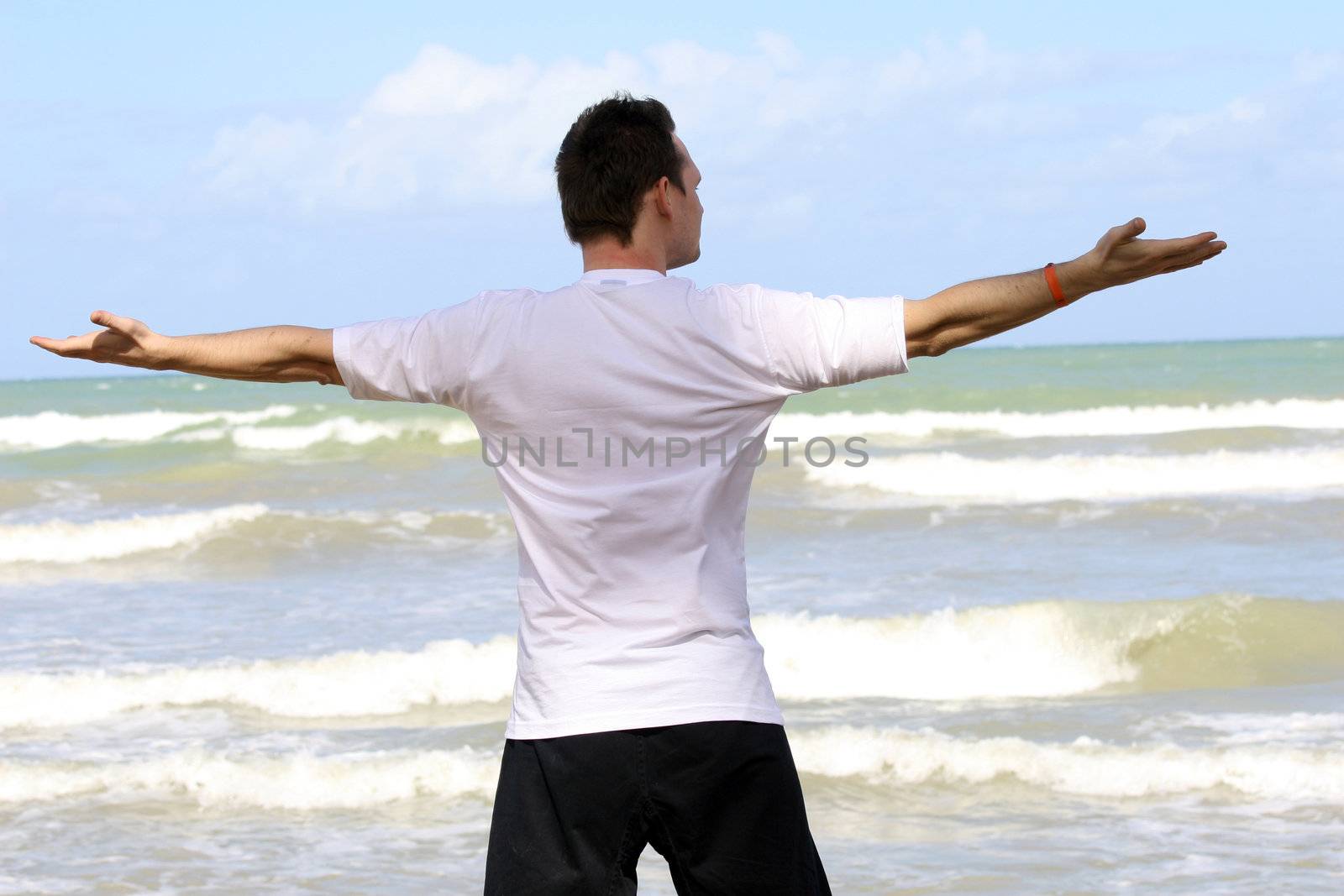 man doing workout exercises on the beach
