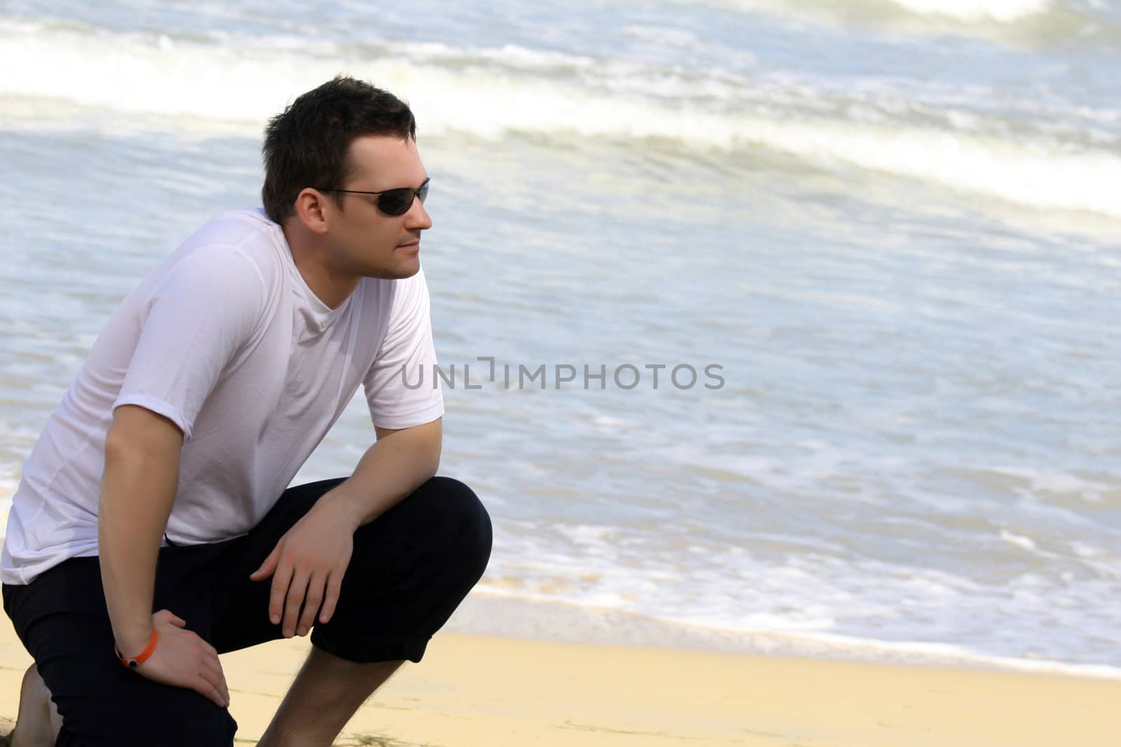 man posing on the caribbean beach