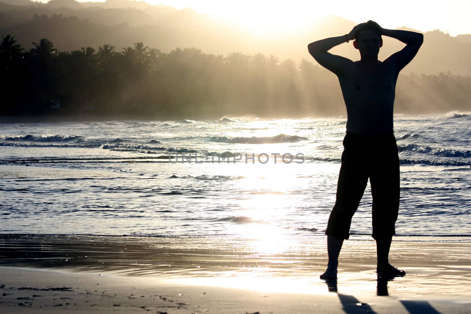 man on the beach by sunset