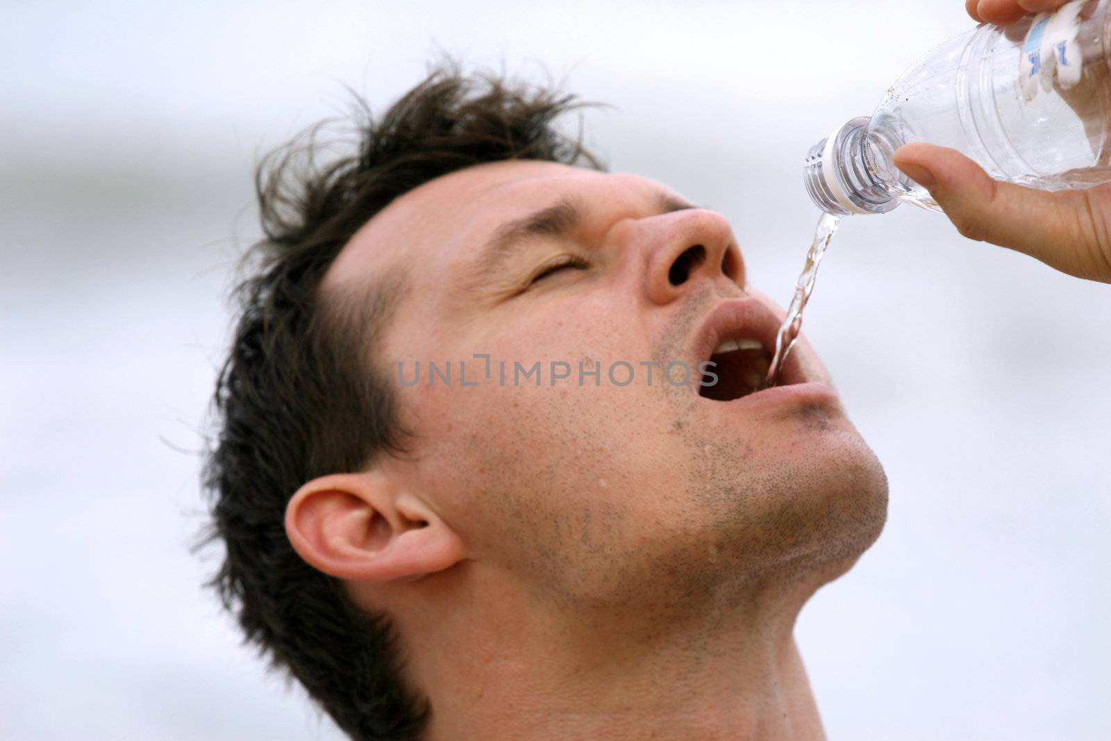 man drinking water after sport training