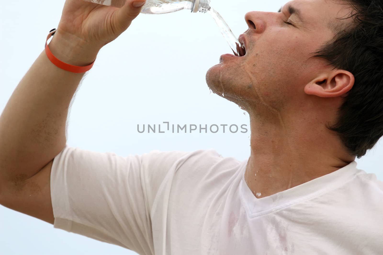 close up of a man drinking water after sport training