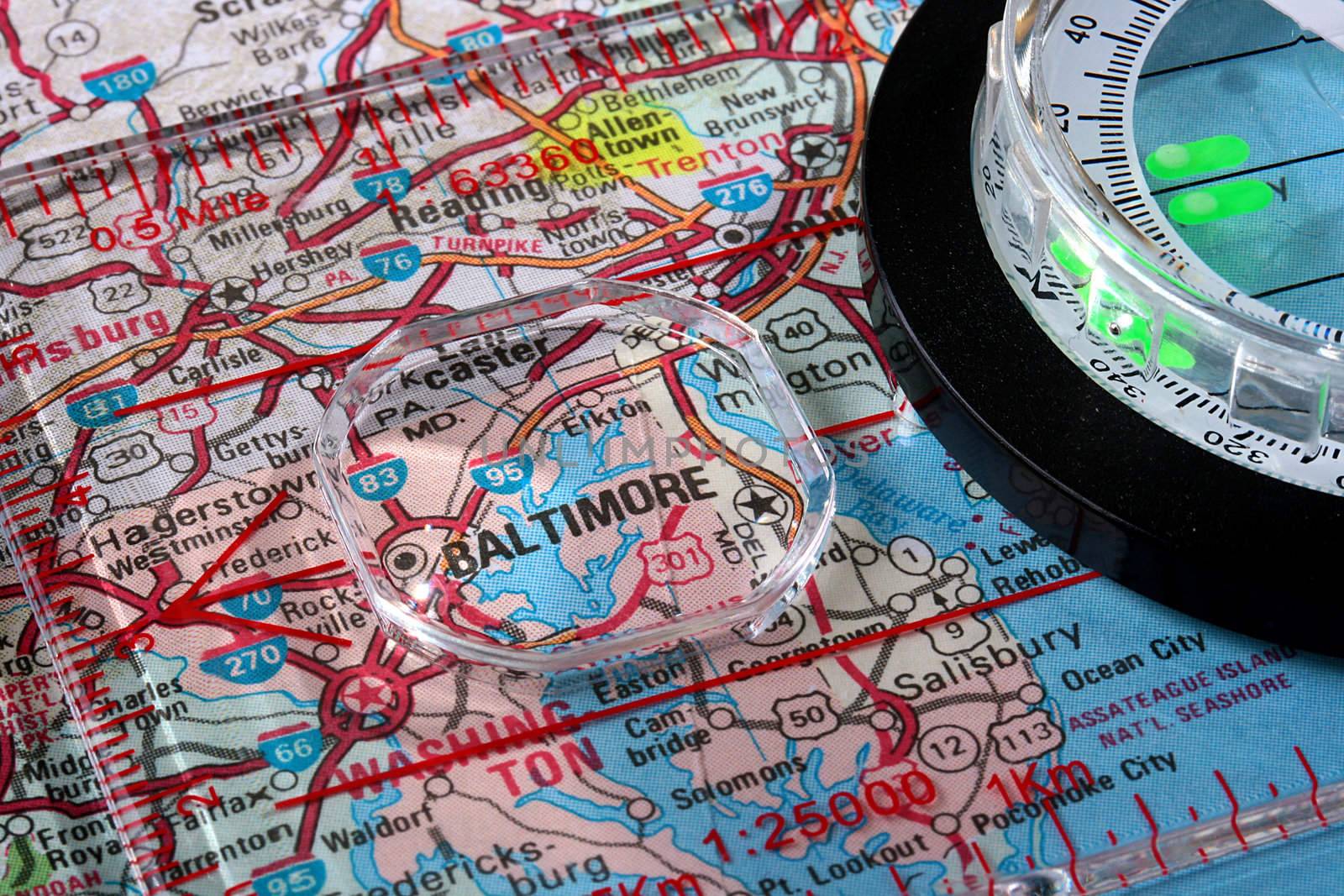 USA map with the city of Baltimore and a compass with magnifying glass over Baltimore.