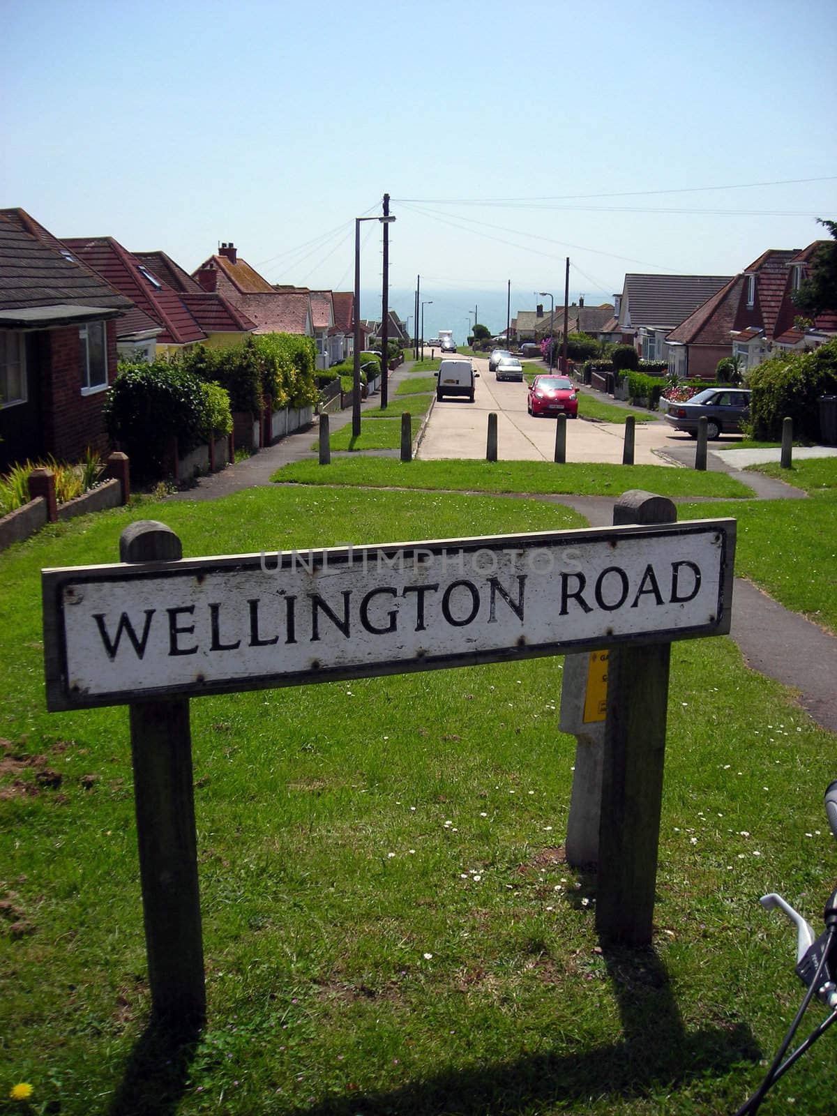 Road sign at Rottingdean, East Sussex, with the ocean in the distance.