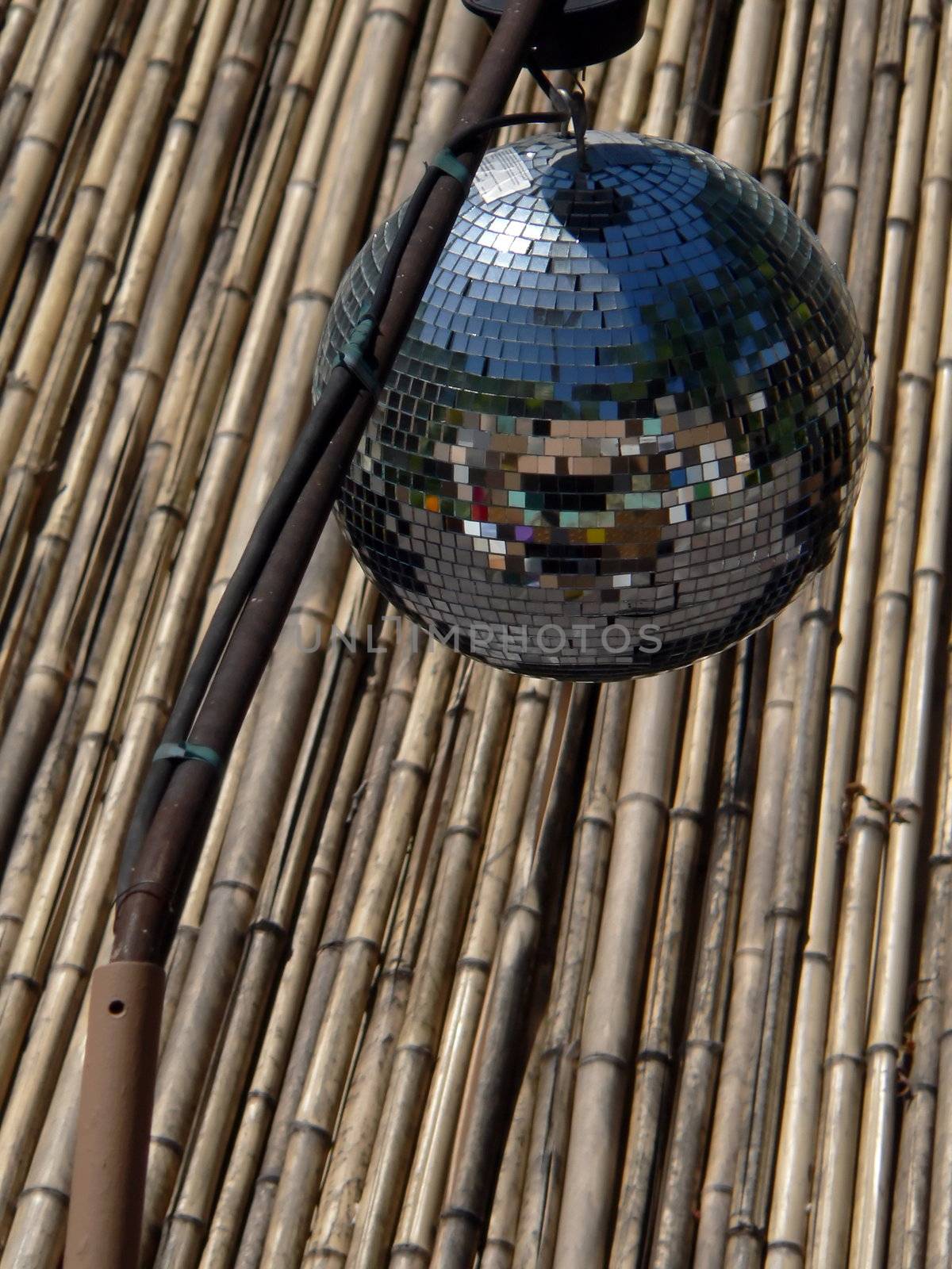 Mirrors ball on the reed roof background