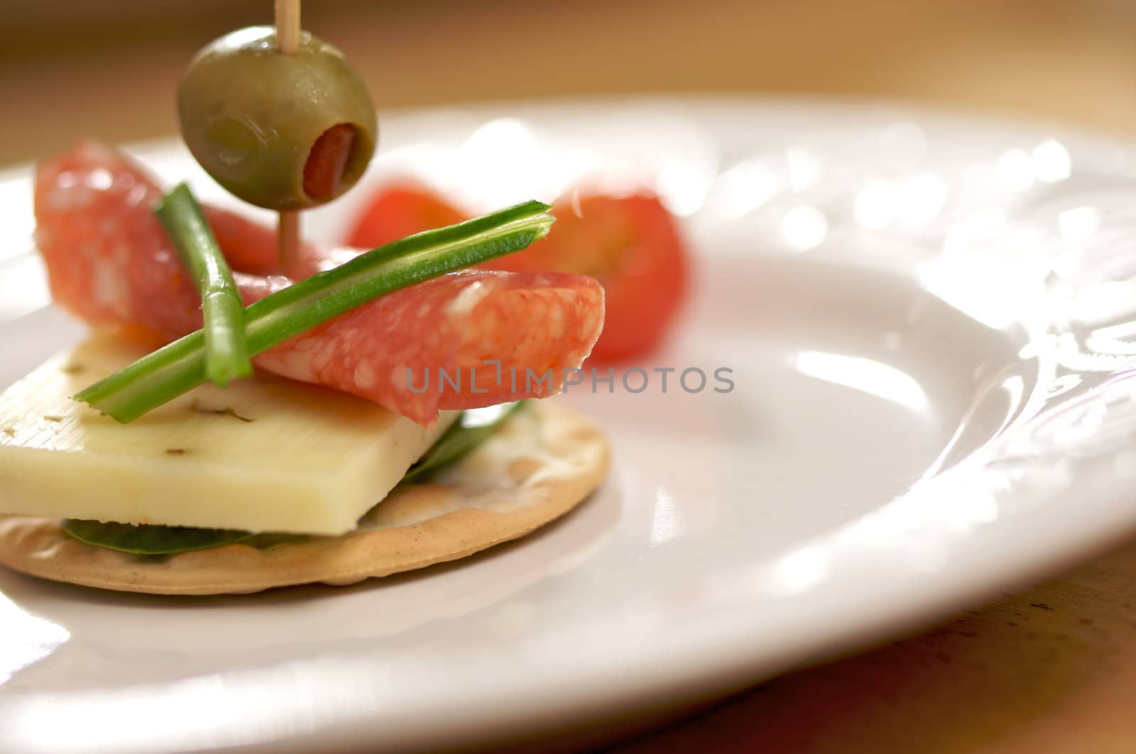 Cracker Appetizers with cheese, olive and pepperoni.