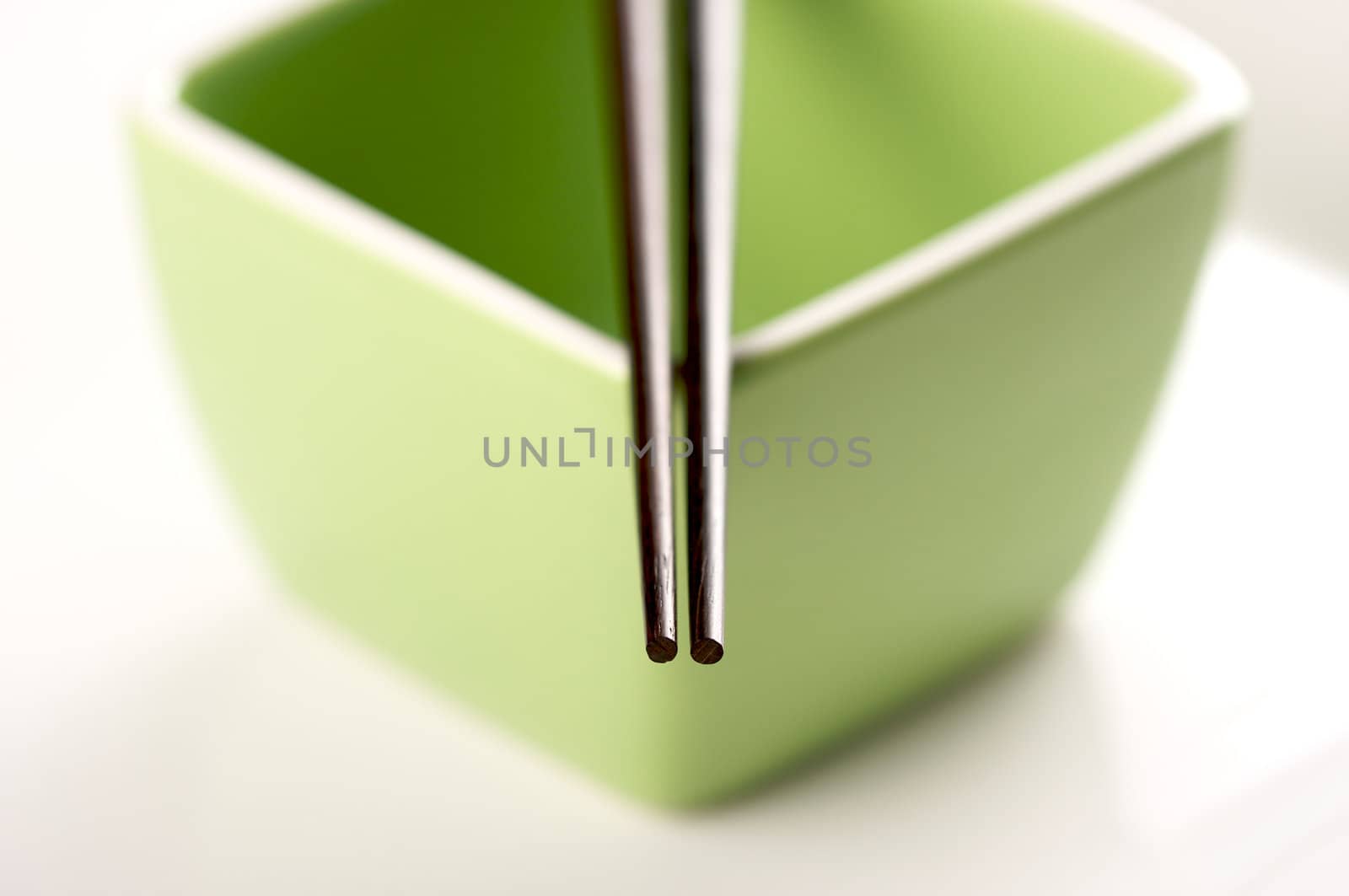 Chopsticks & Green Bowl on a white background.