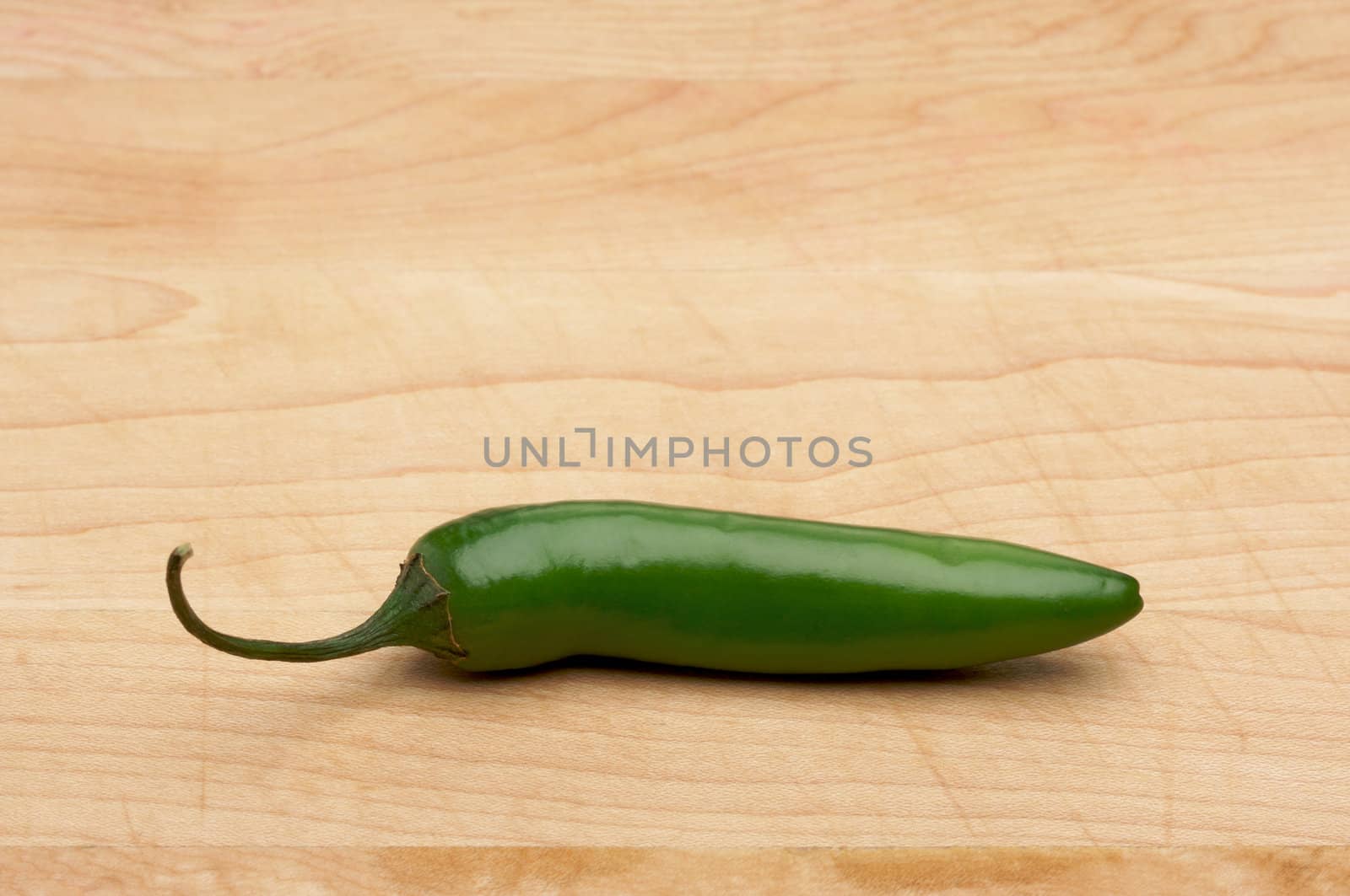 Hot Chili Pepper on a Wood Cutting Board - Room for Copy at the Top.