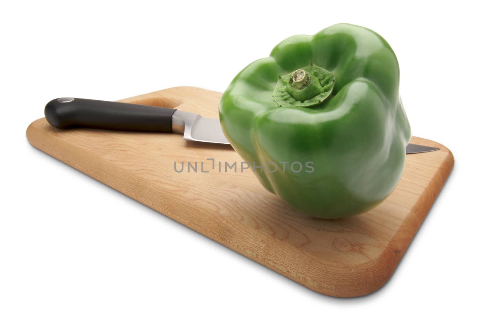 Green Bell Pepper and Knife on a Wood Cutting Board