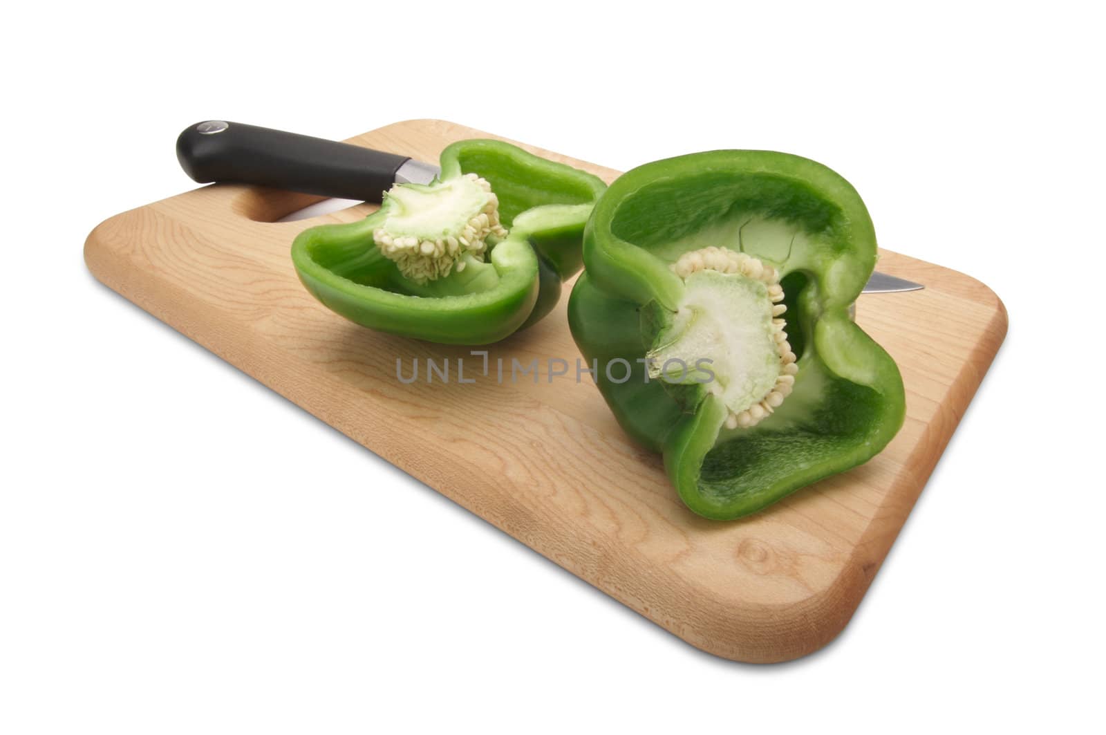 Cut Green Bell Pepper and Knife on a Wood Cutting Board