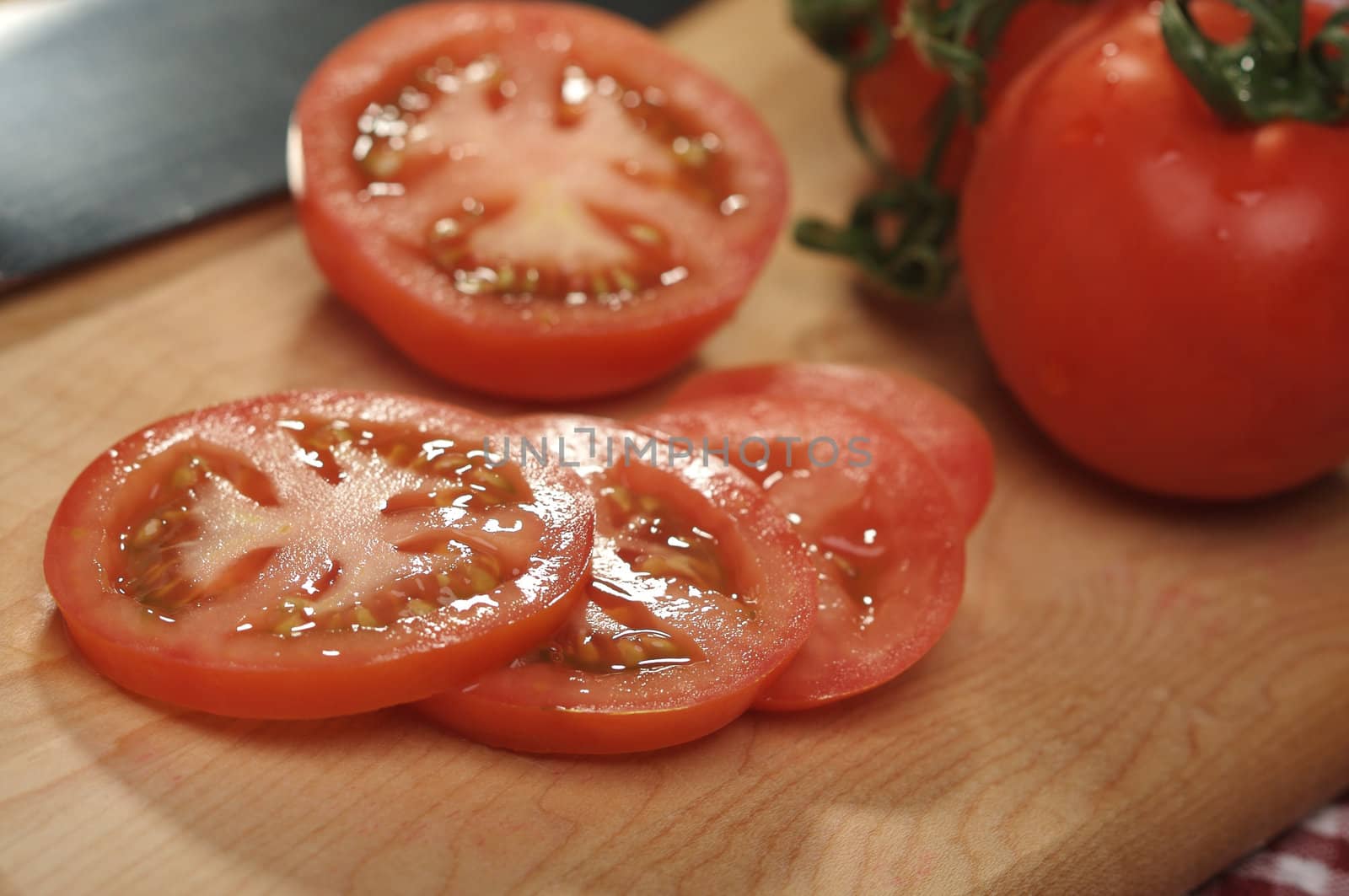 Fresh Cut Tomato on a Cutting Board