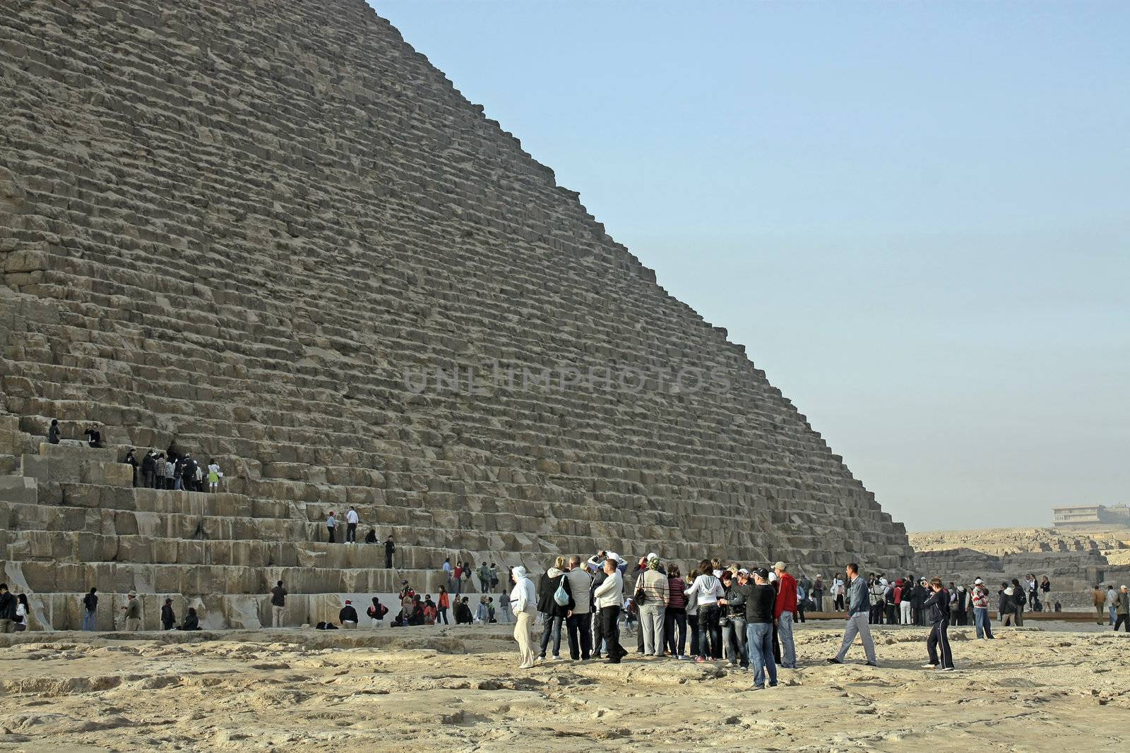 Egypt, Cairo, Giza. A lot of people and looking at the pyramid of Cheops.