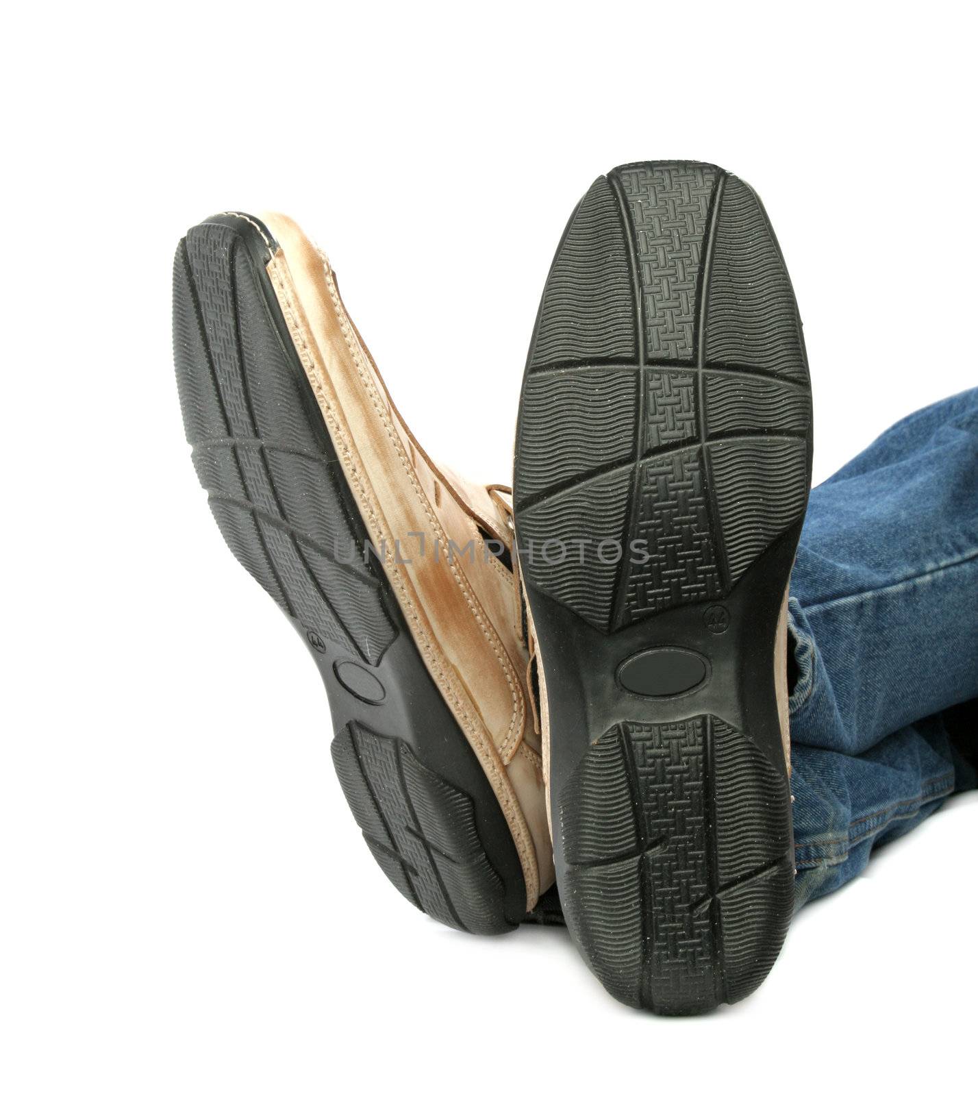 Human foot with brown leather shoes and jeans, isolated on white