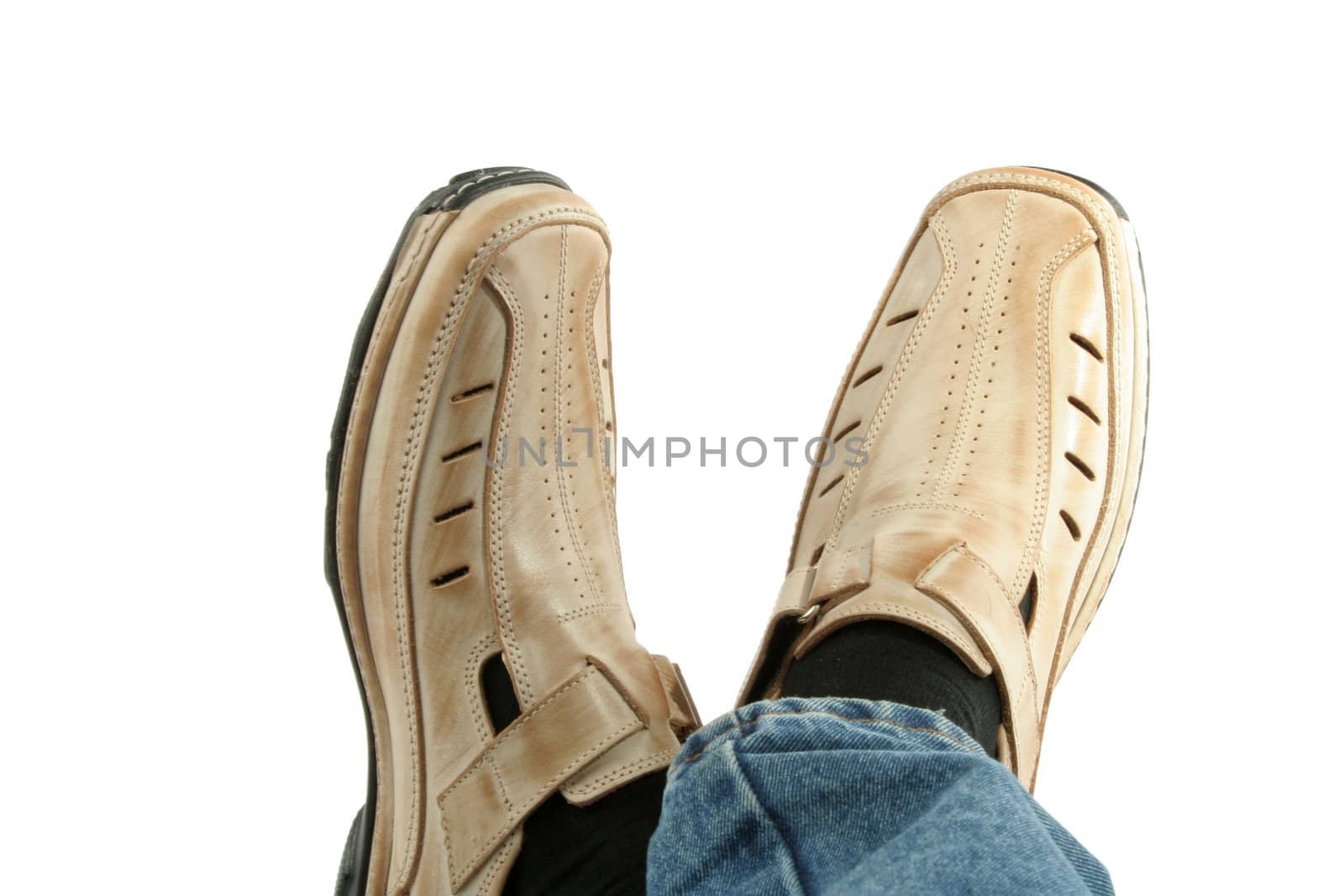 Human foot with brown leather shoes and jeans, isolated on white