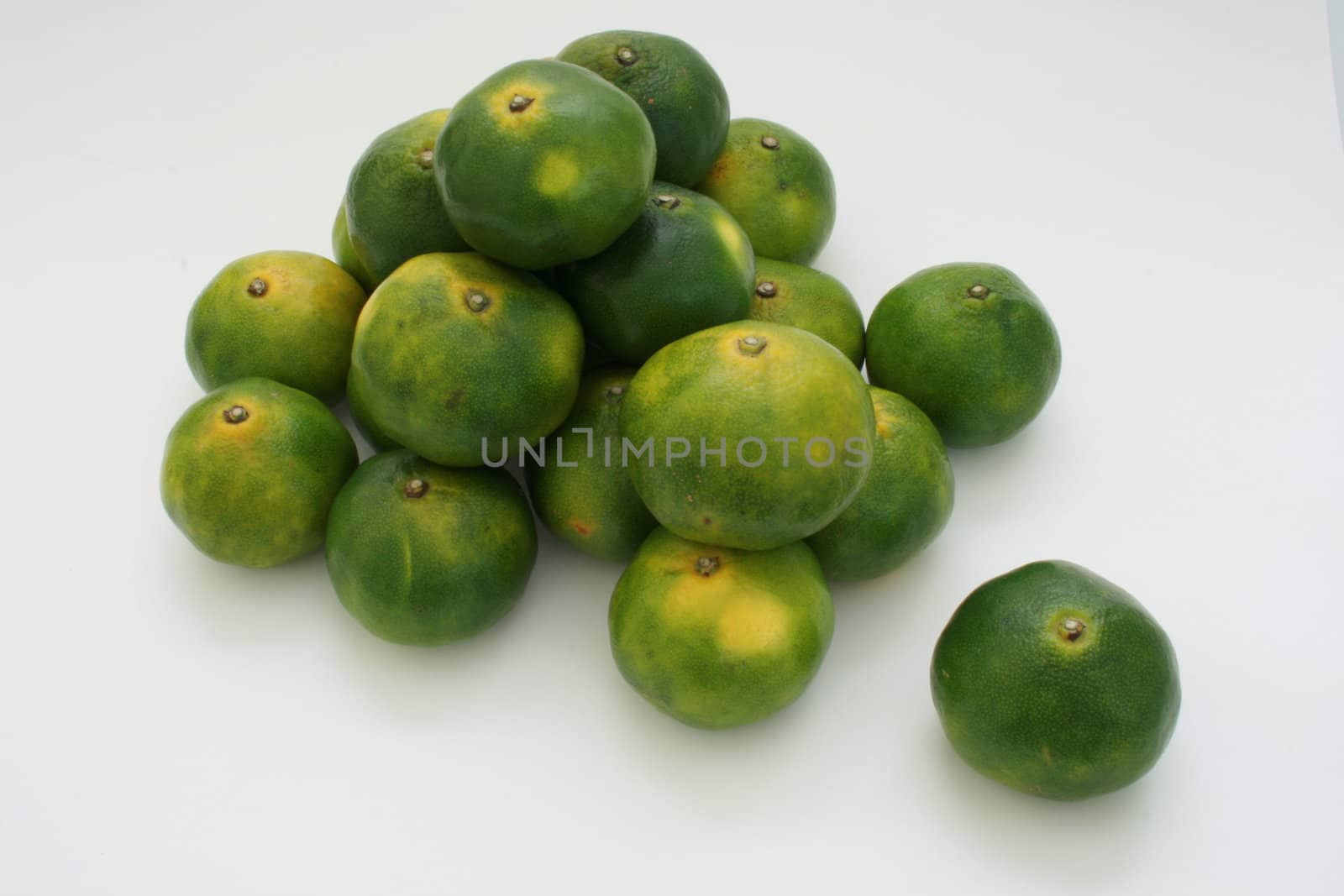 a bunch of oriental green citrus fruit
