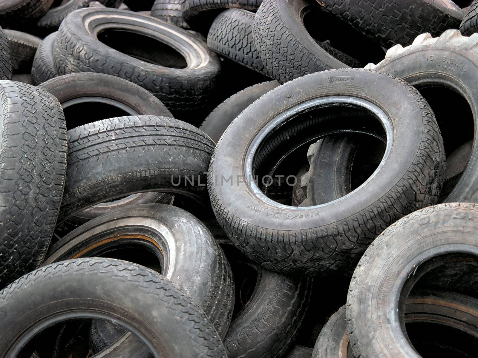 A heap of discarded car and truck tires.  35mm film scan.
