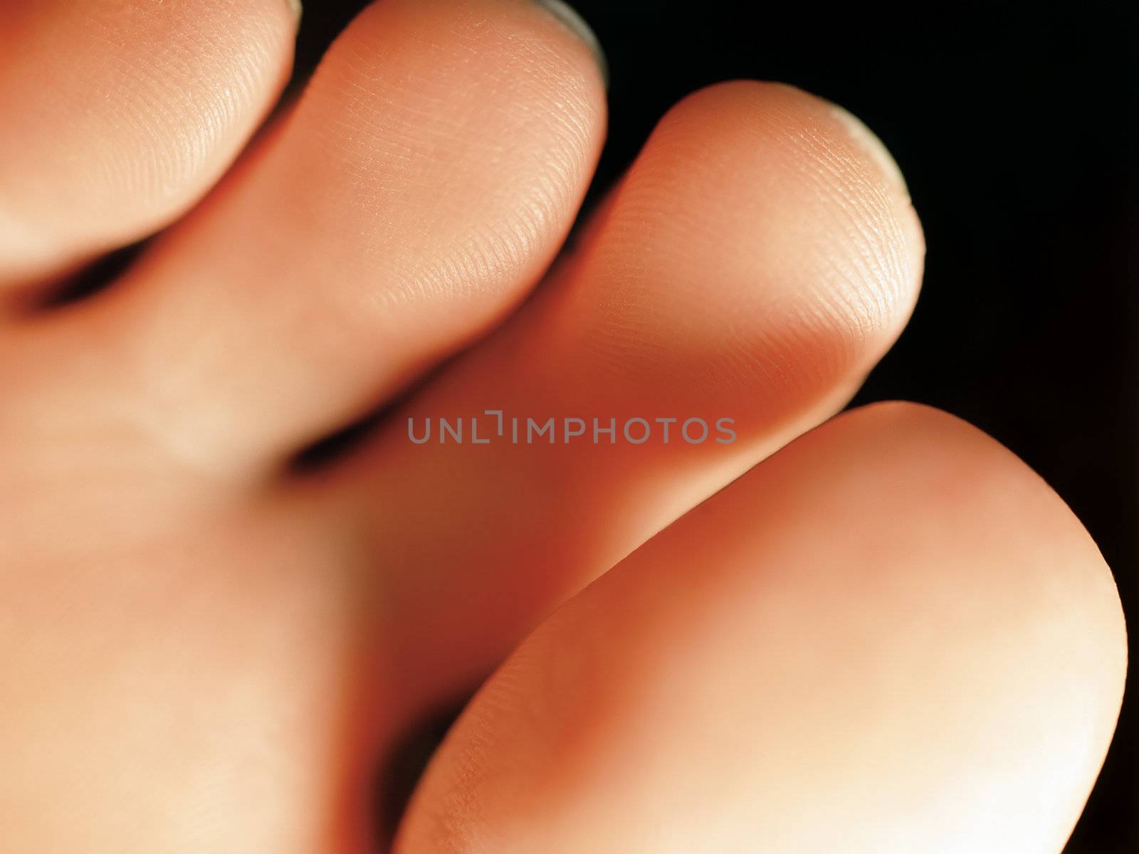 Macro and extreme shallow depth of field image of the bottom of a females toes. Film scan.