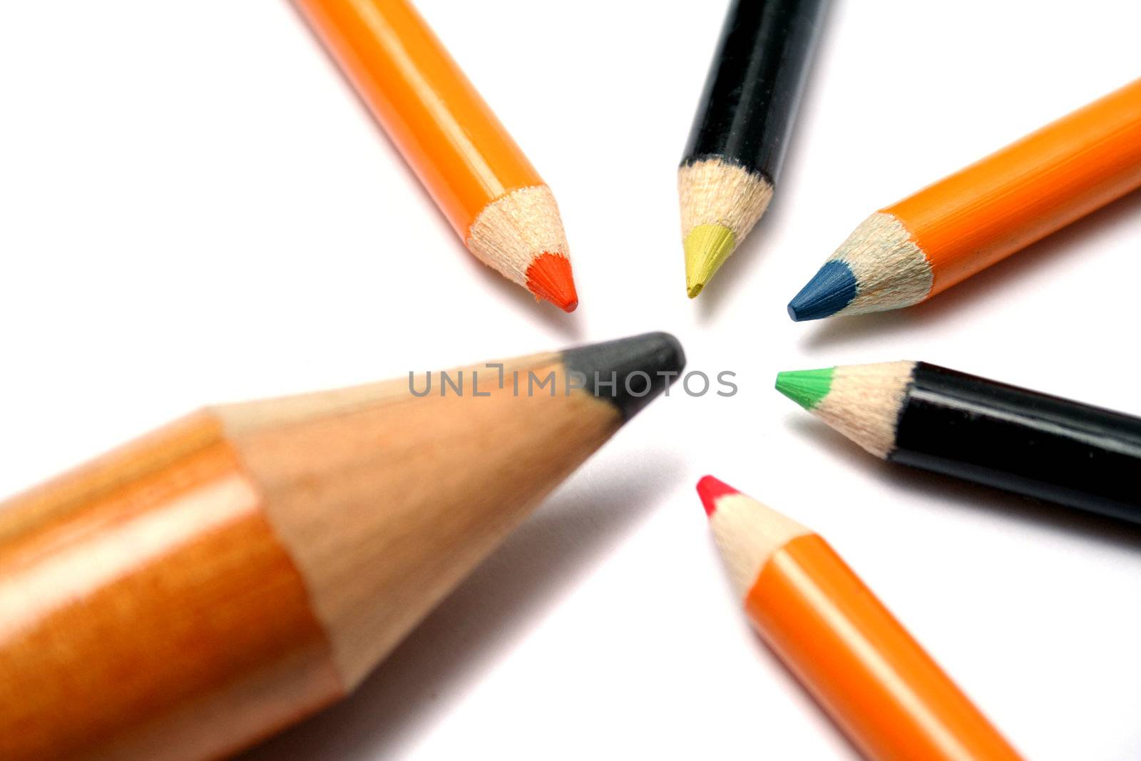 The big pencil and five small color pencils on a diagonal by parrus