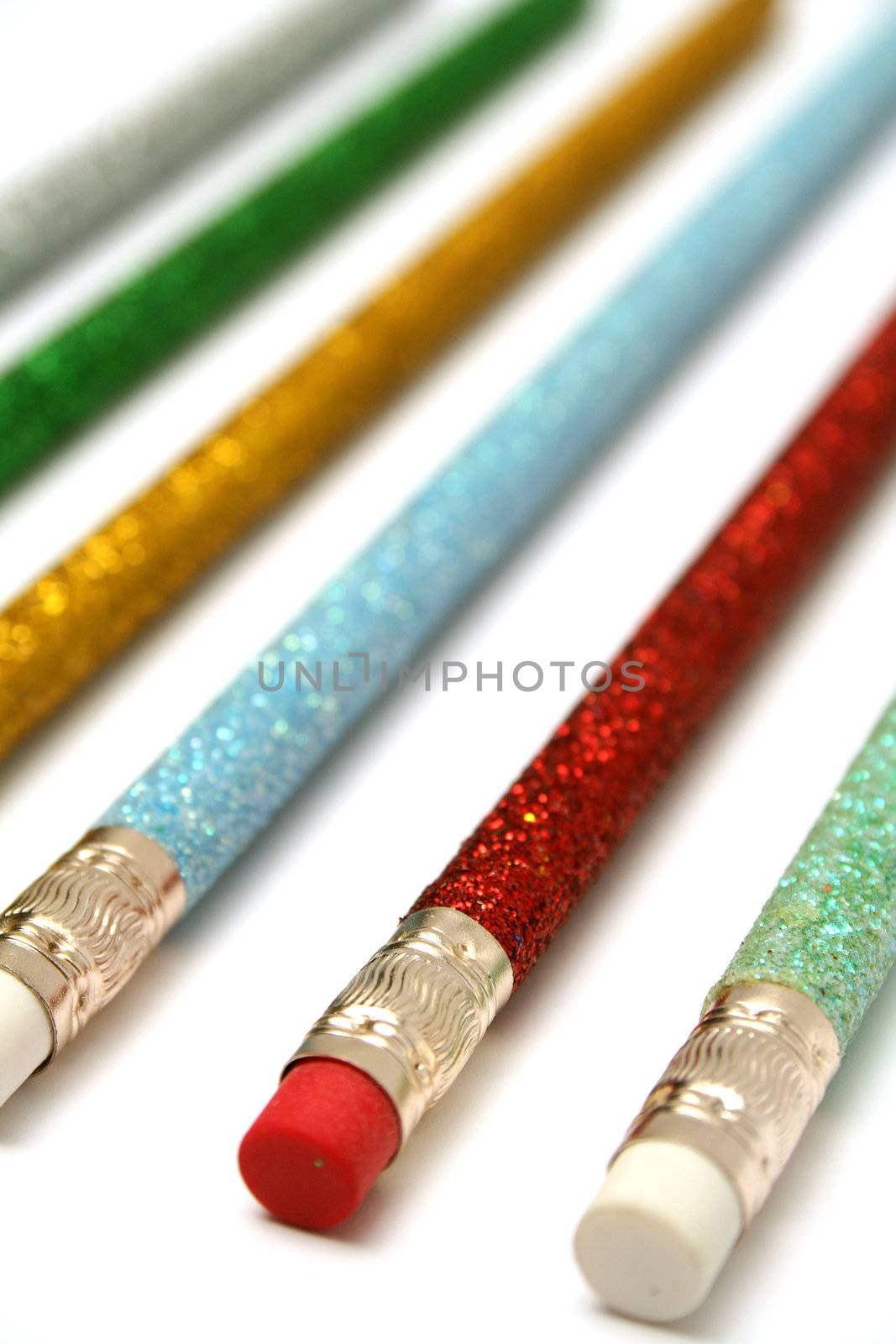 Set of celebratory color pencils with a multi-coloured sparkling covering macro