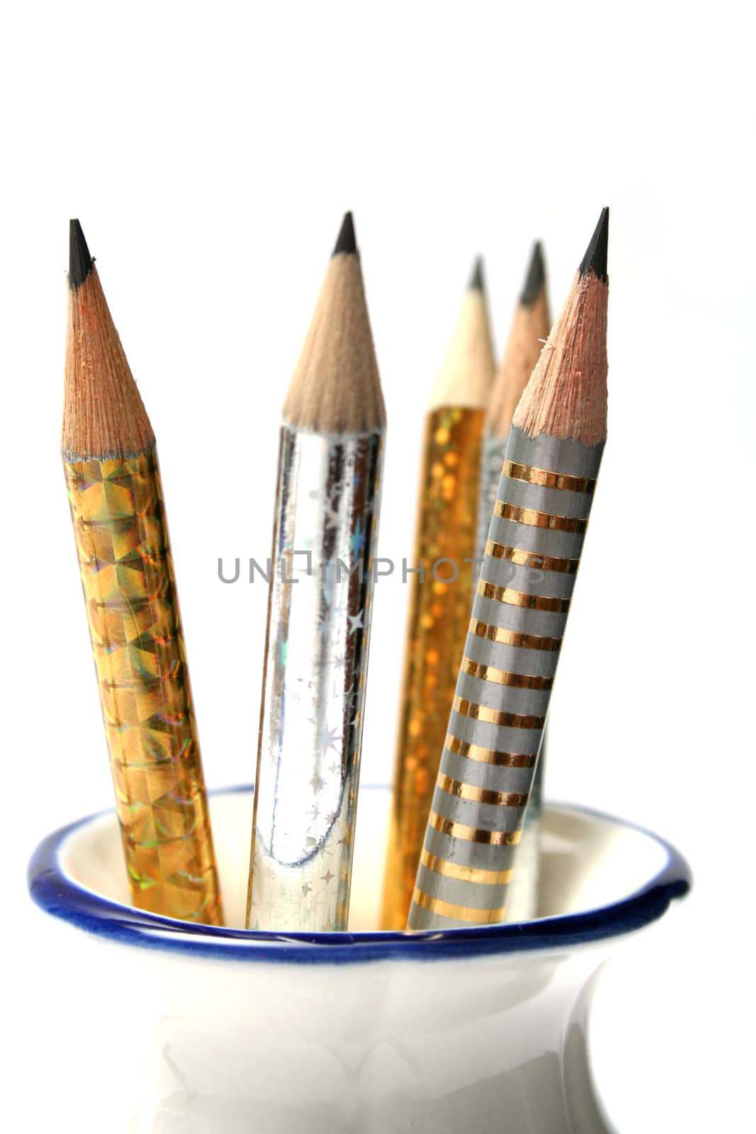 Set of celebratory sparkling pencils standing in a vase by parrus