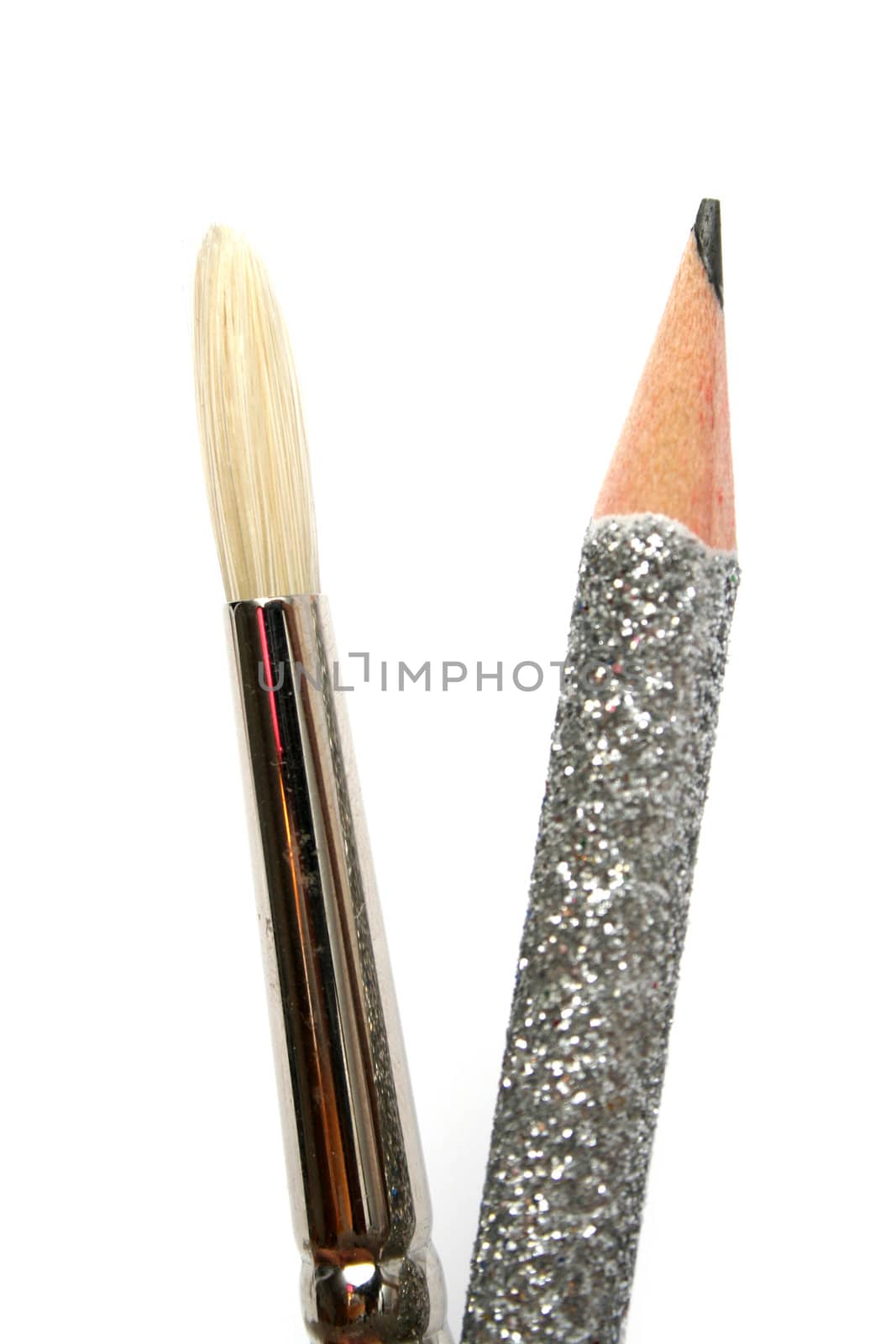 Art brush near to a celebratory brilliant pencil for plotting by parrus