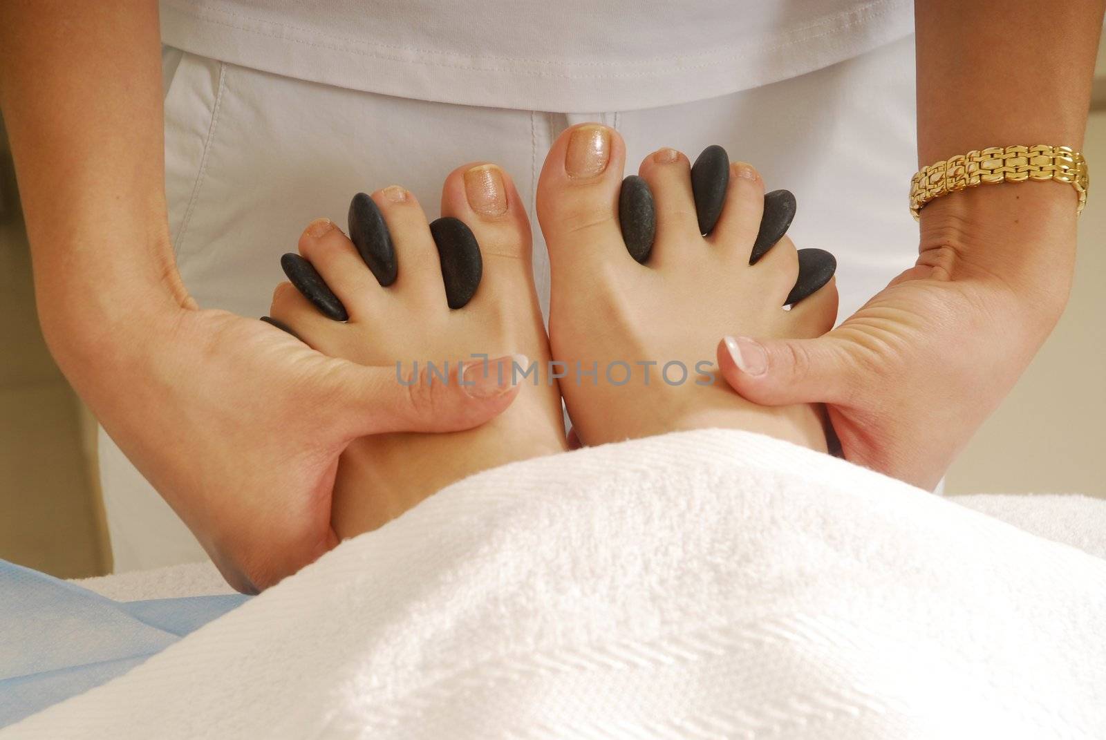 Dark gray stones in the woman feet