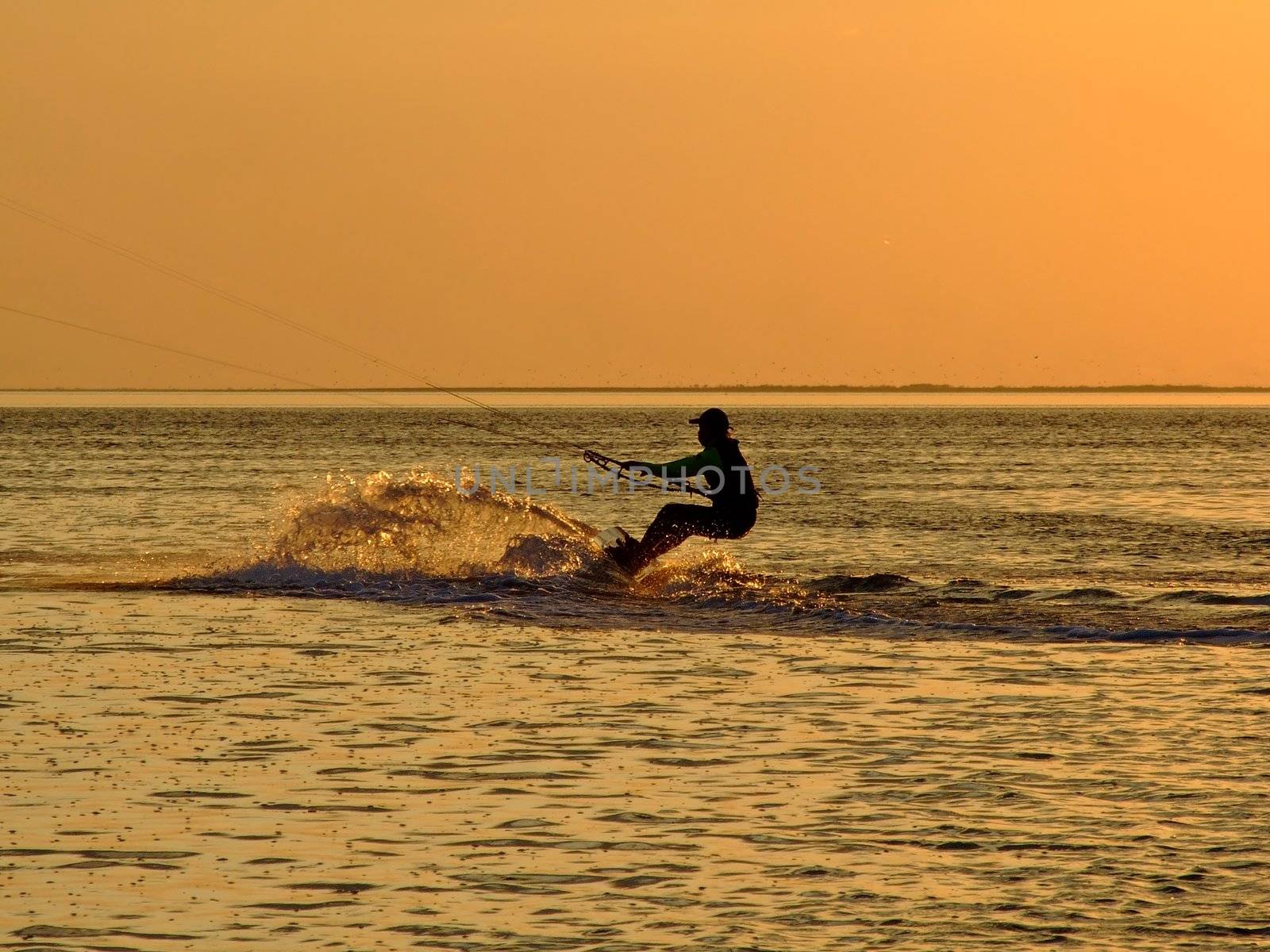 Silhouette of a kitesurf on a gulf on a sunset 2