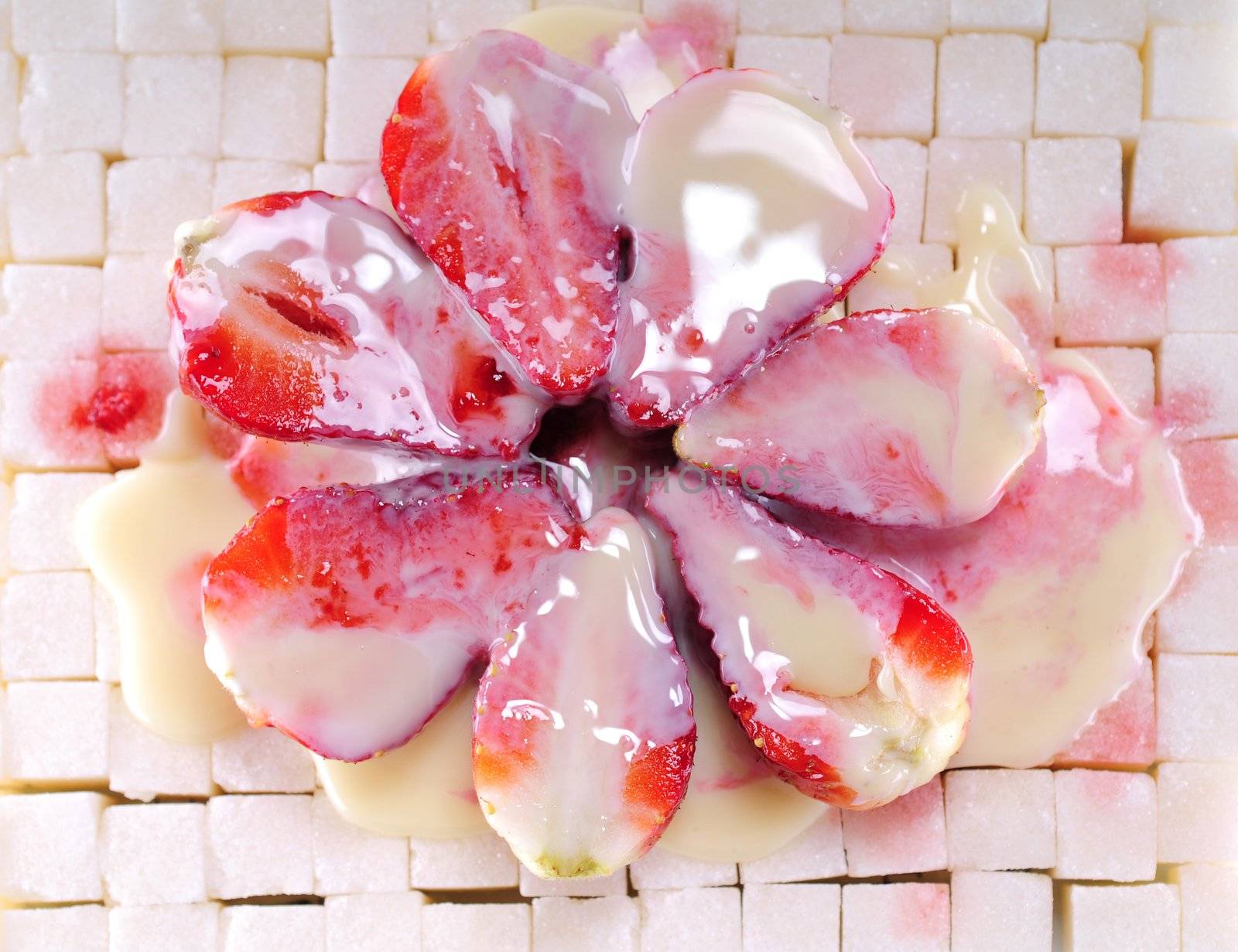 White sugar cubes background with strawberry and milk