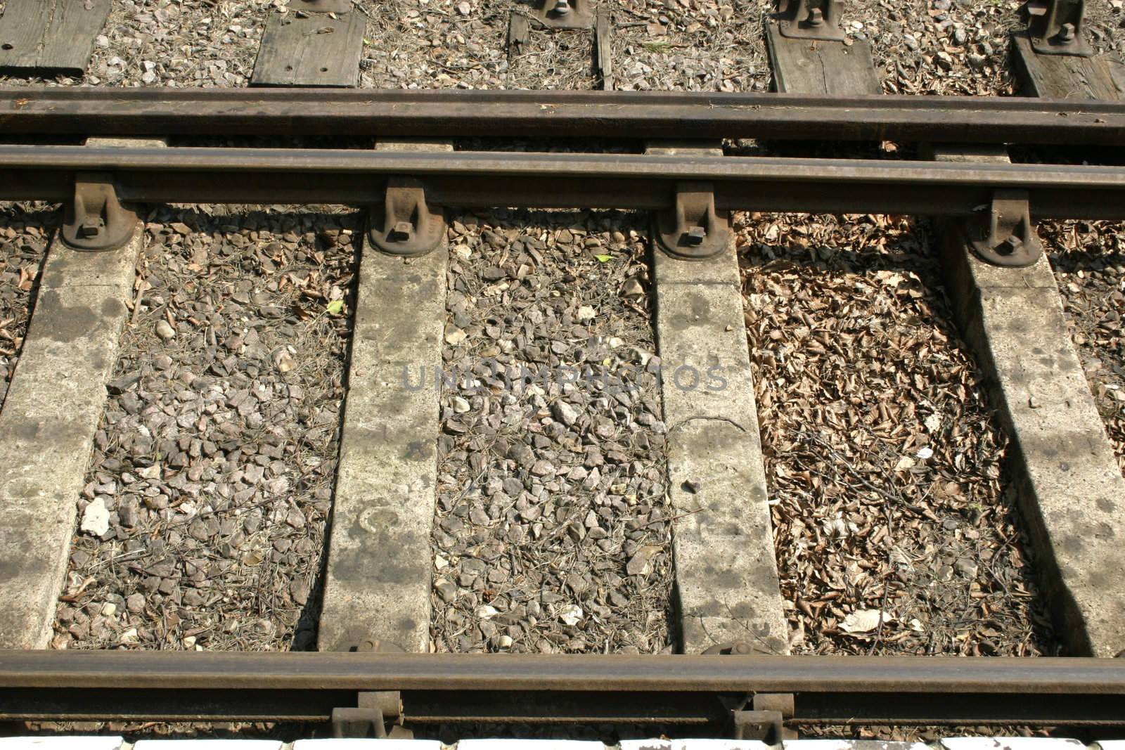 details of the railway track with gravel in between the wooden sleepers