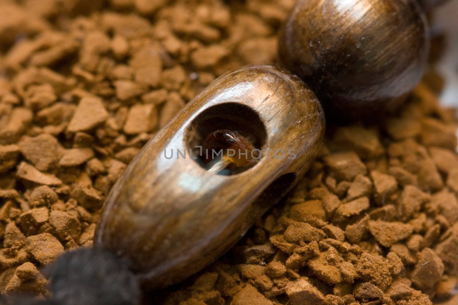 aromatic instant coffee and wooden decoration with amber macro